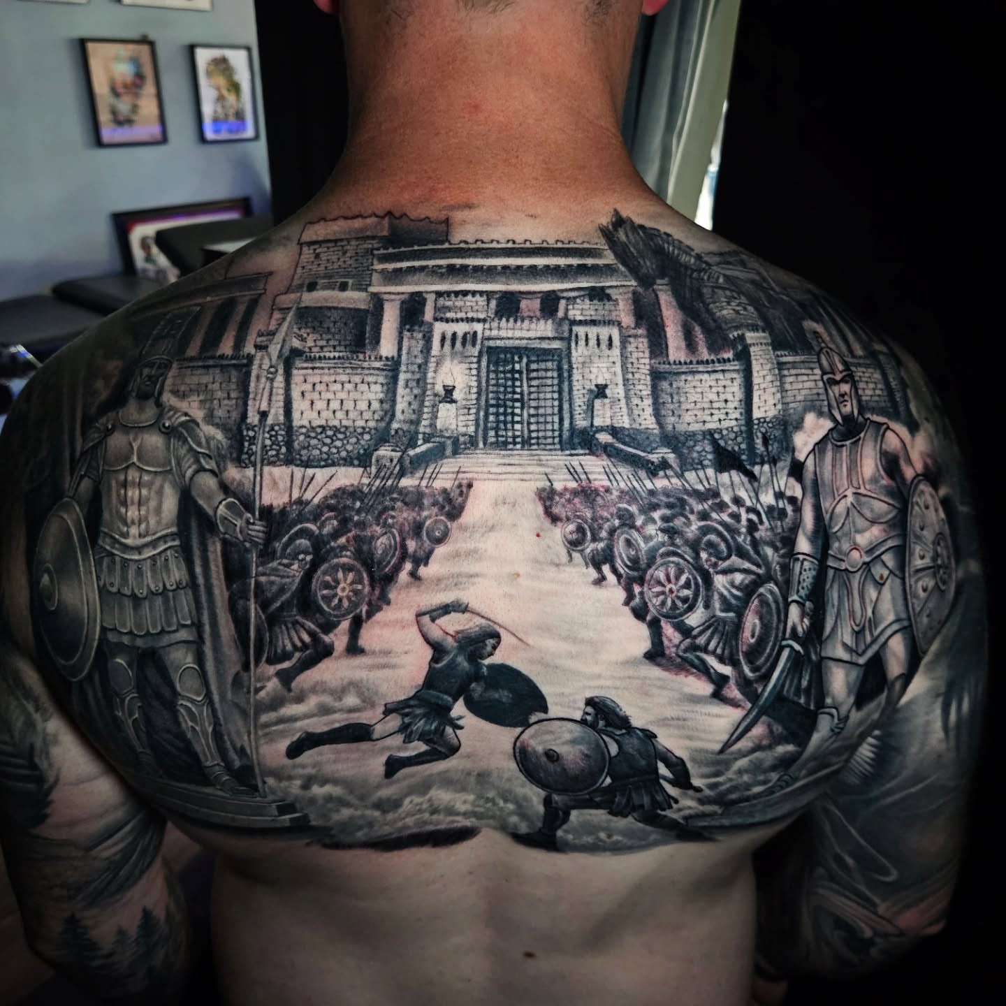 Ancient battle scene realism tattoo on the back by Mike Bugenhagen