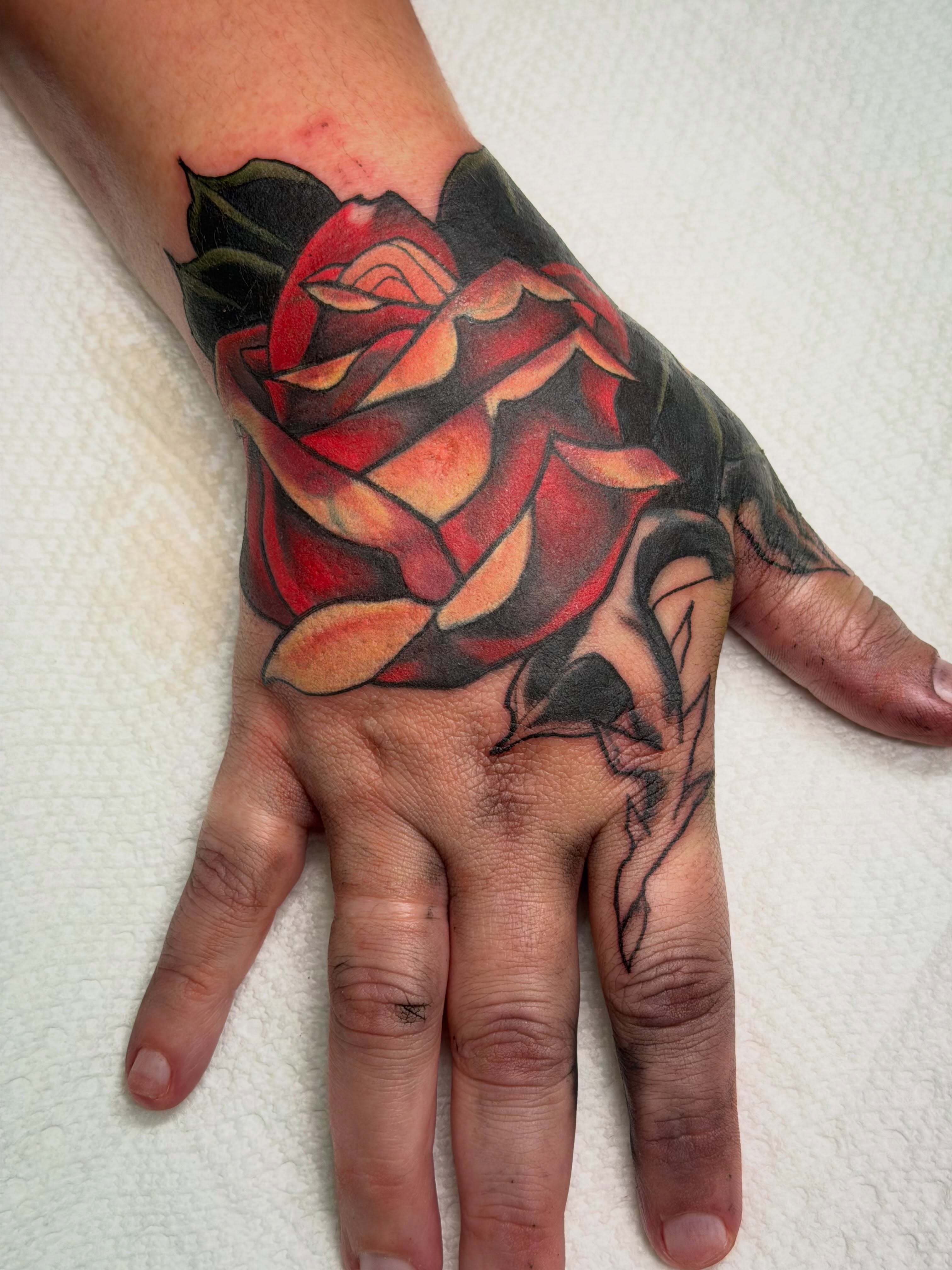 Rose realism tattoo on the hand by Colbylee Tattoo Norwich