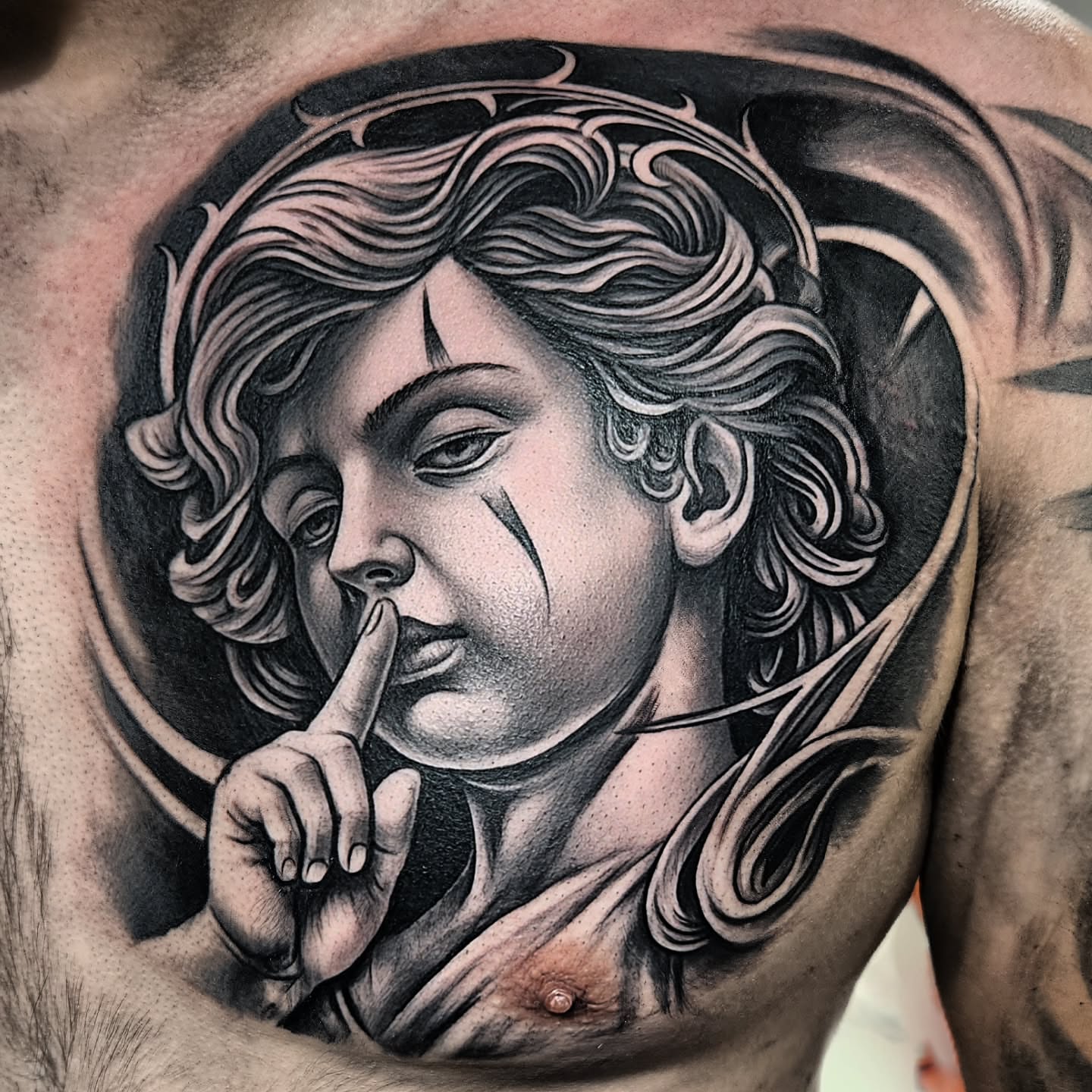 Woman with finger on lips realism tattoo on the chest by "El Jose" Tattoo