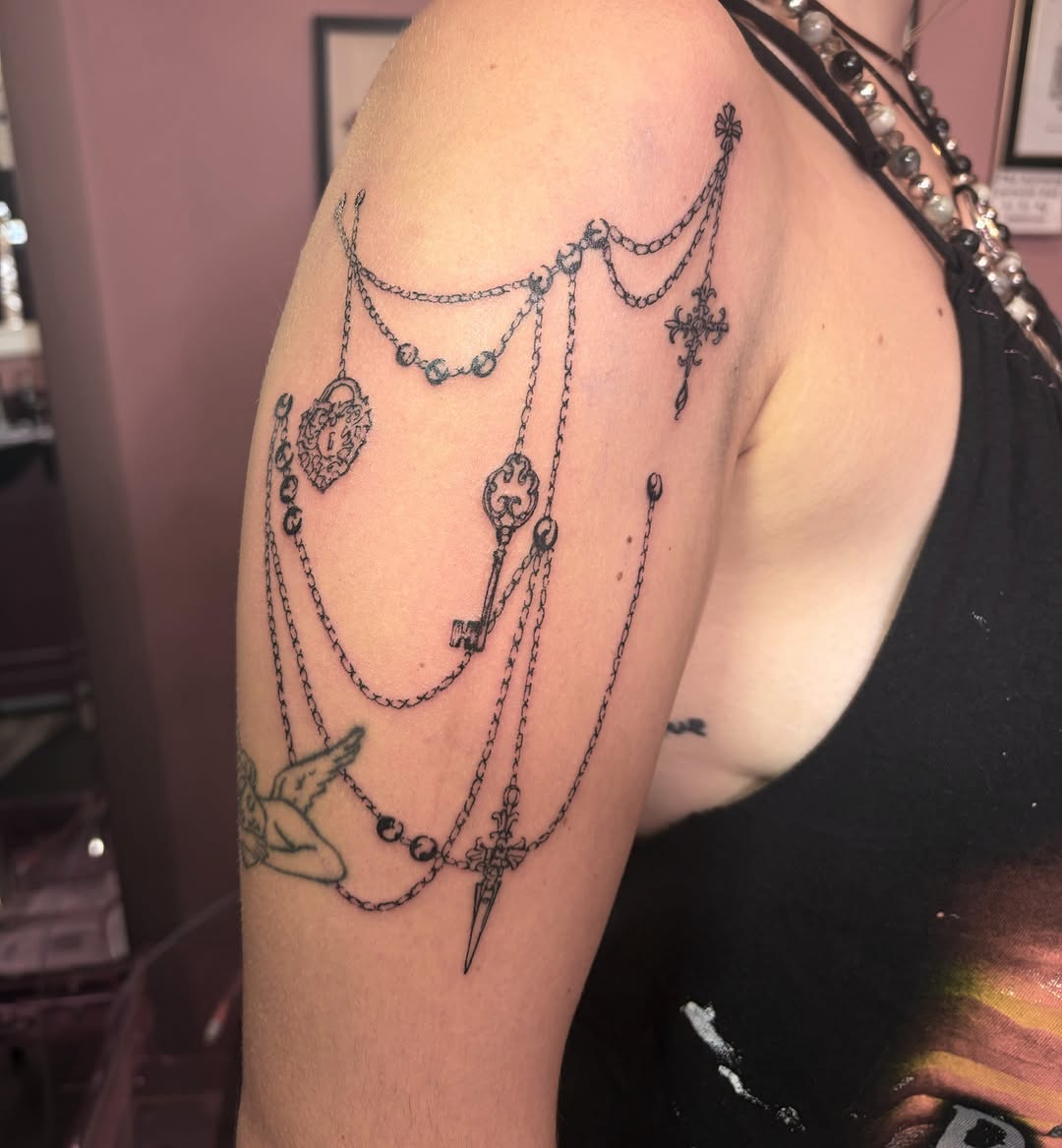 Chains and keys black and grey tattoo on the shoulder by Mary Hannah Sosdian