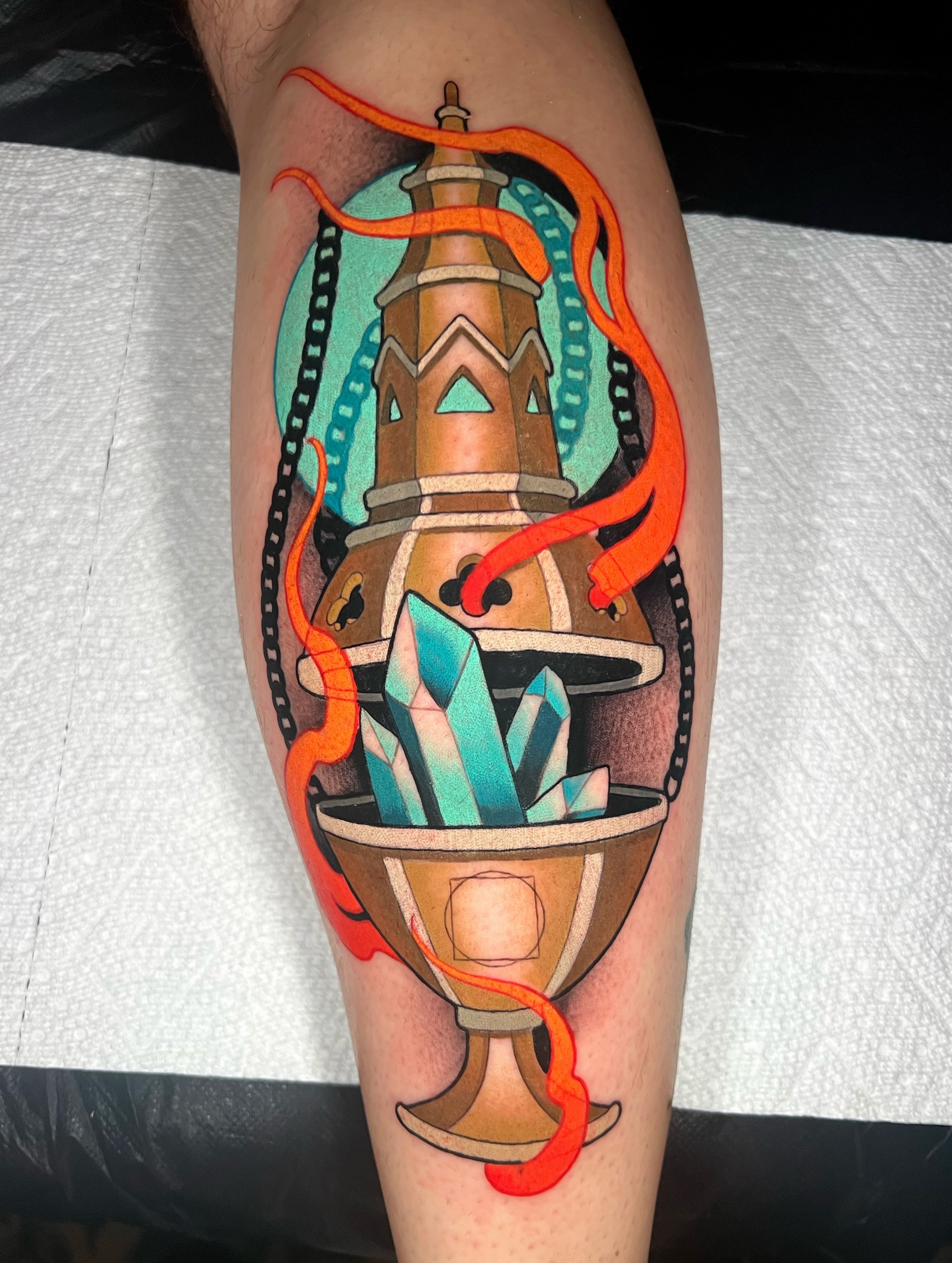 Crystal and tower geometric tattoo on the forearm by Skyler Miller