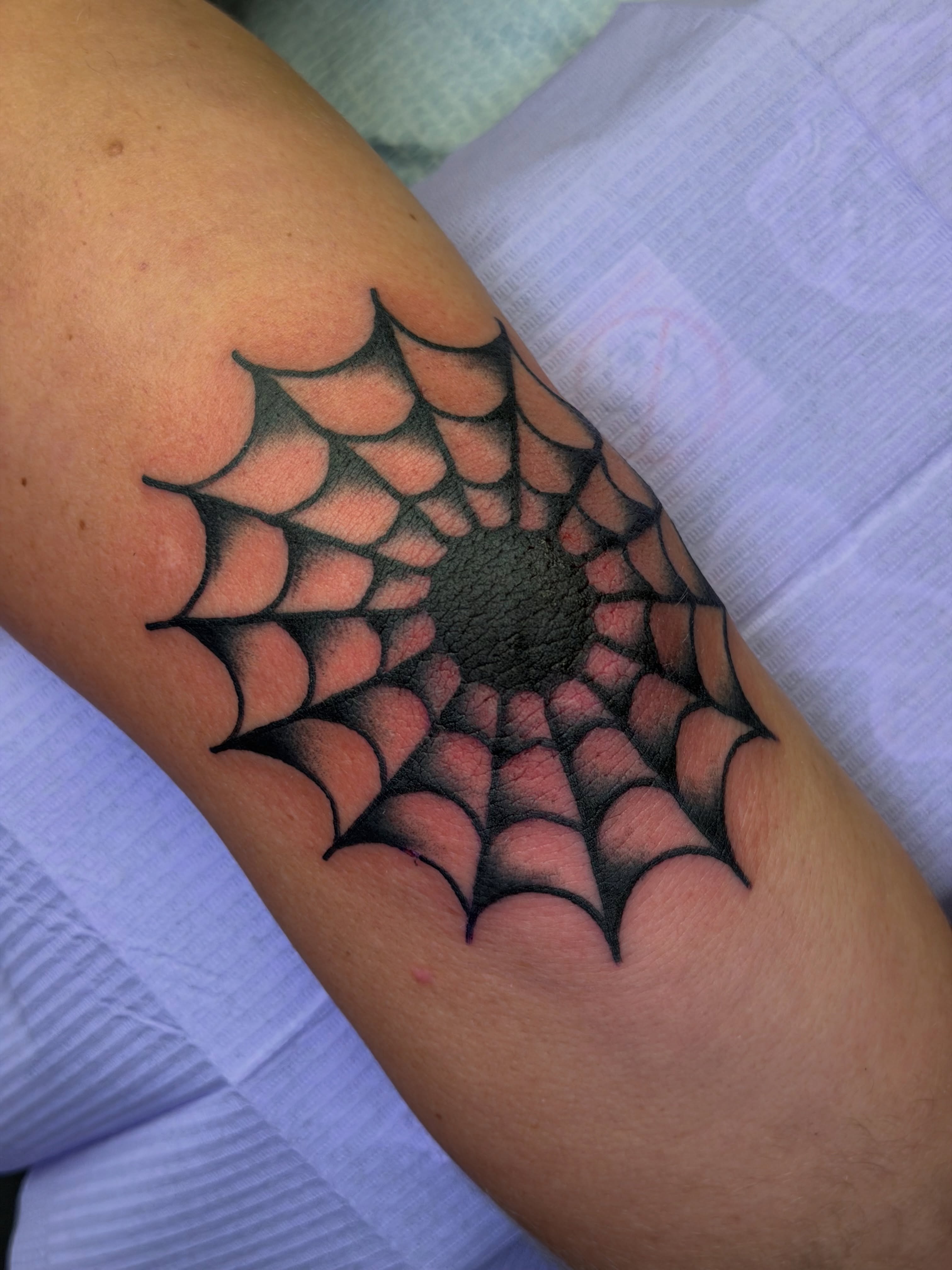 Spiderweb geometric tattoo on the forearm by @ryanpereztattoo