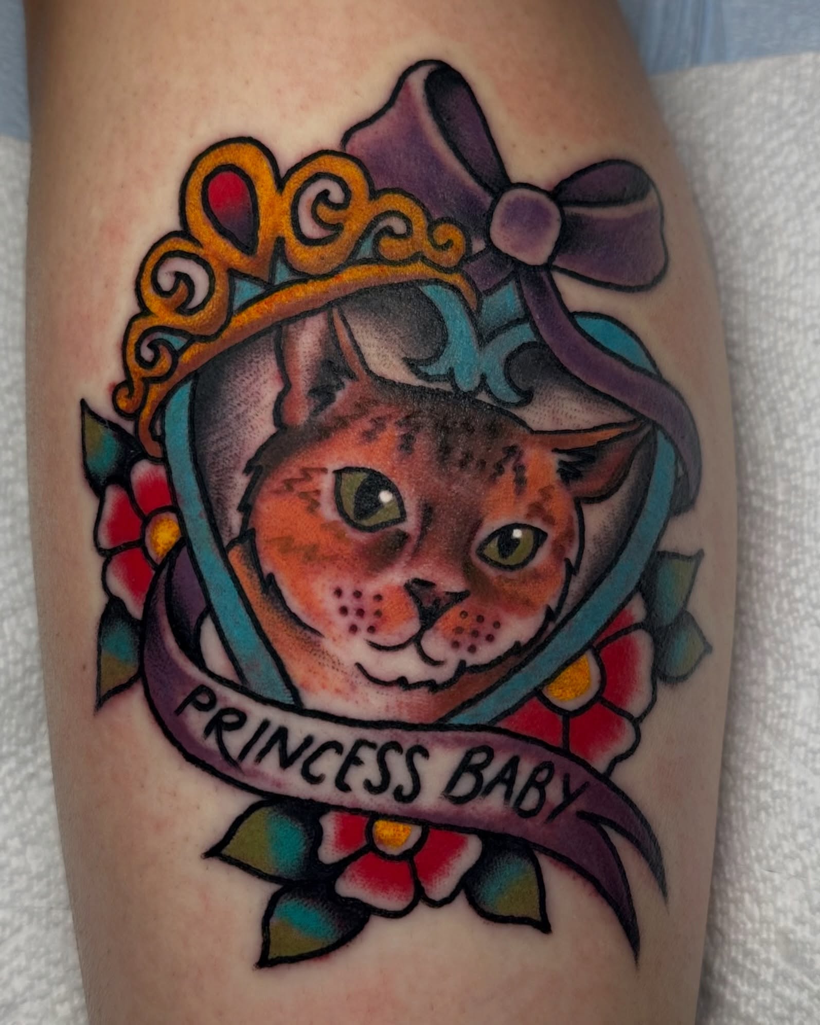 Cat with crown American traditional tattoo on the forearm by rachel knabe