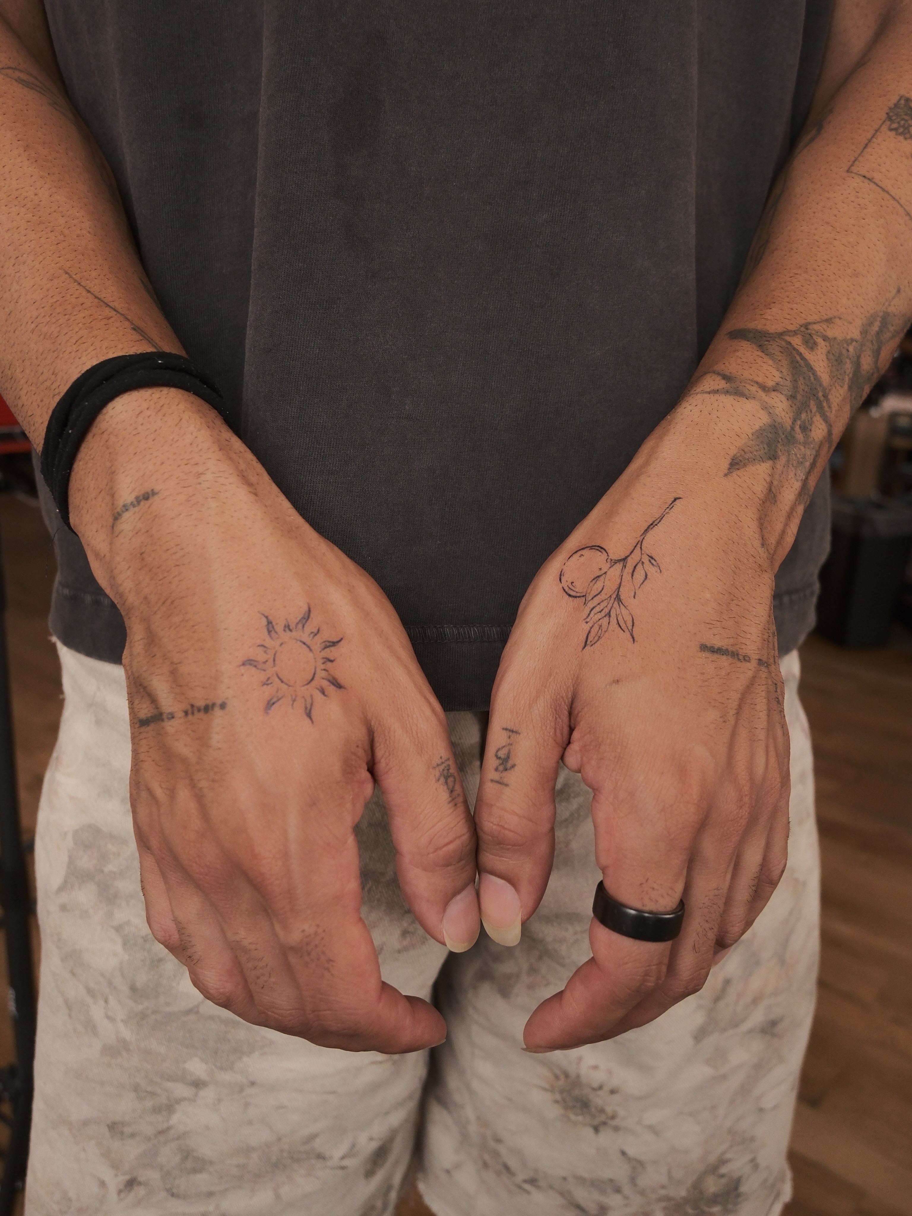Sun and branch black and grey tattoo on the hand by Ethan