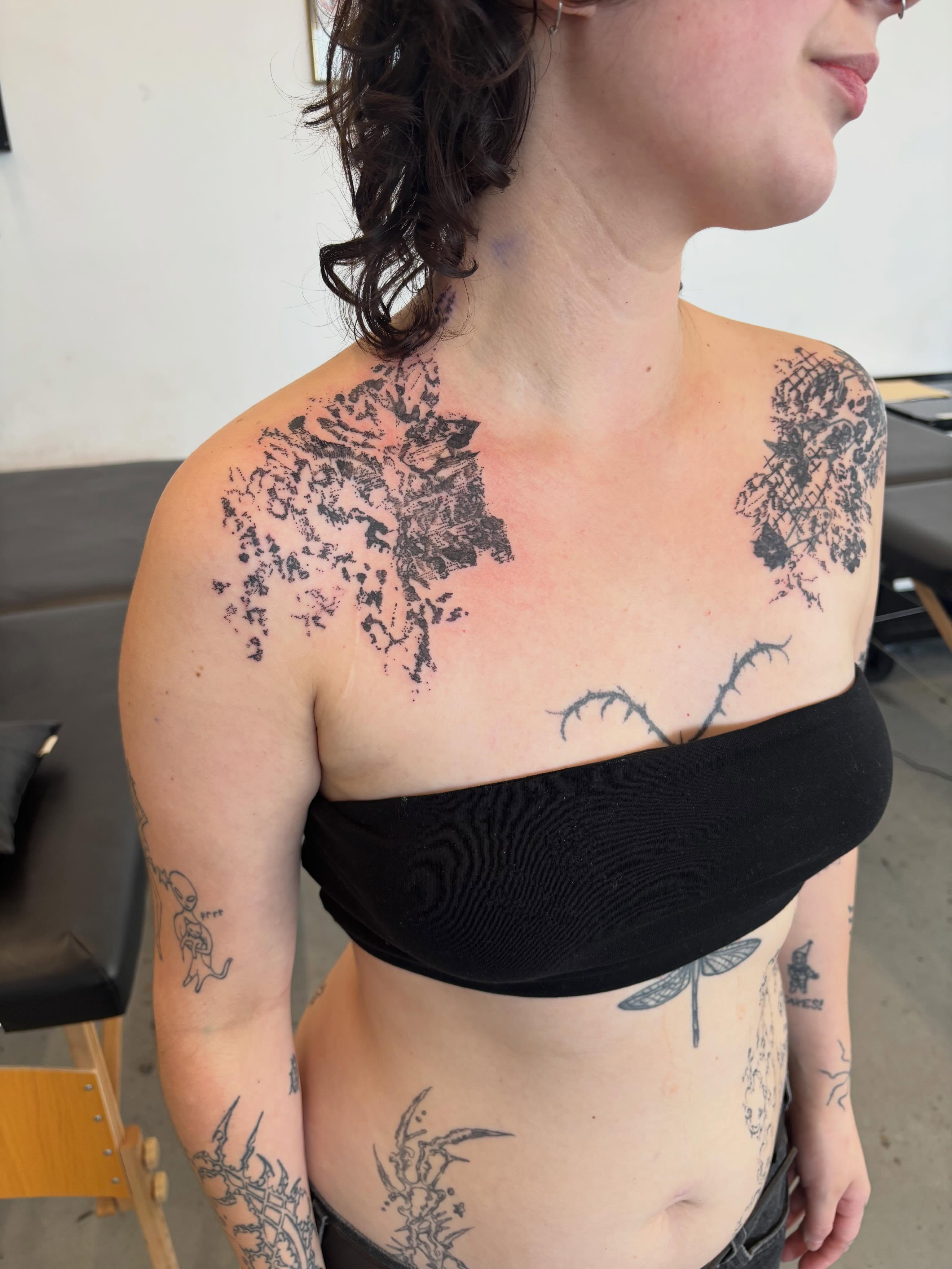 Abstract floral dotwork tattoo on the chest by madeline