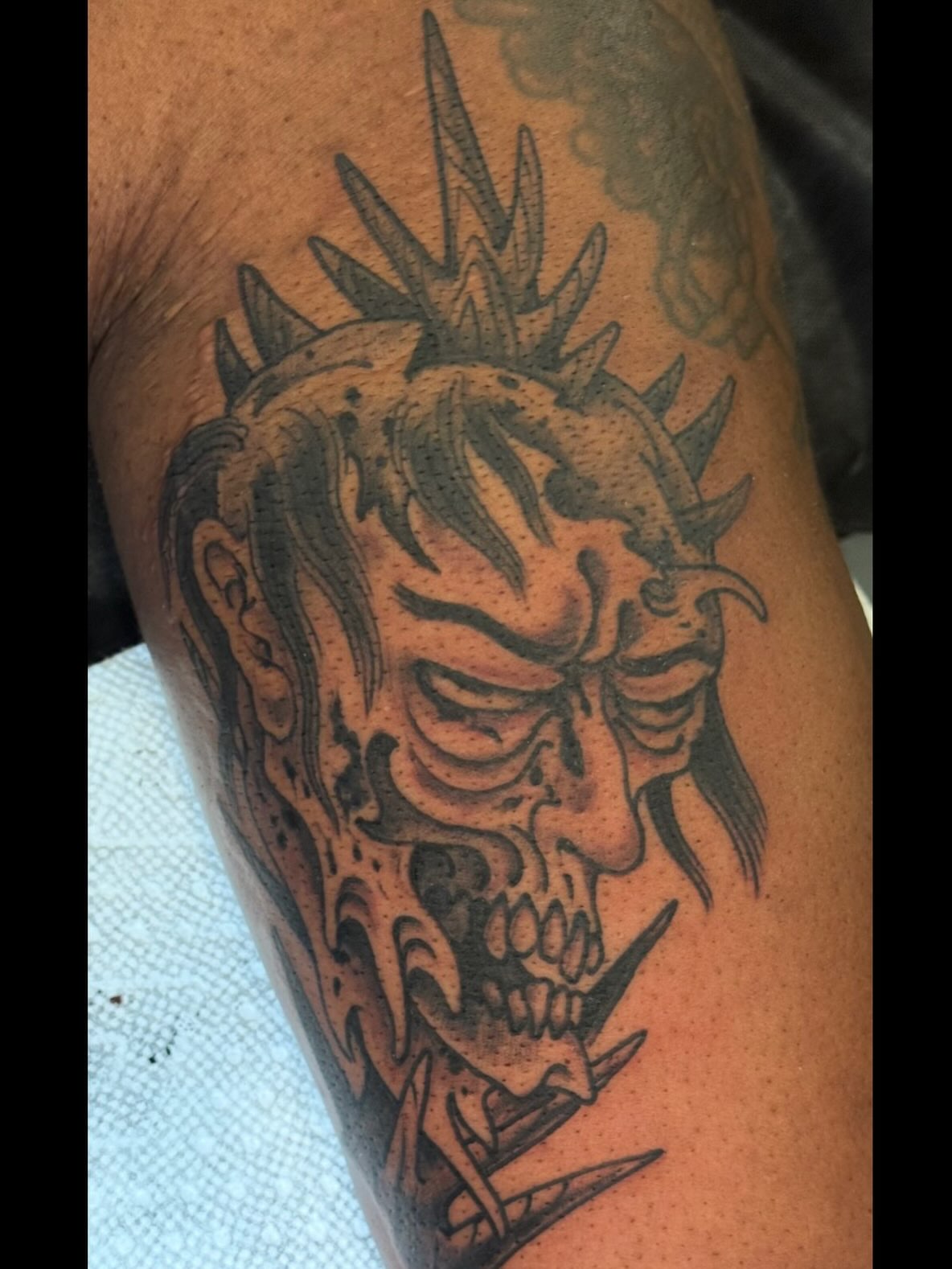 Demon skull dark realism tattoo on the forearm by Candi Kinyōbi