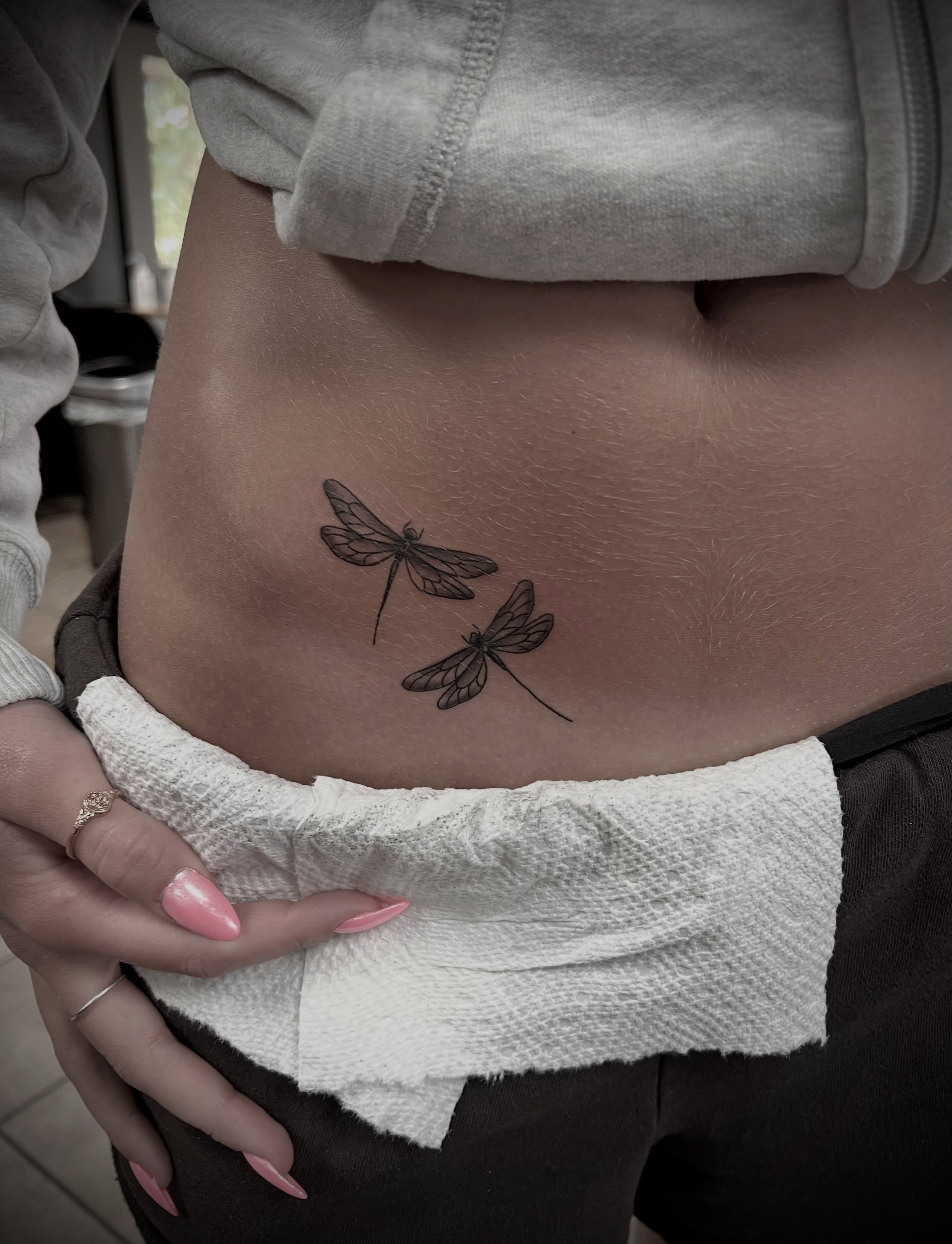 Dragonflies black and grey tattoo on the ribs by Austin Hill