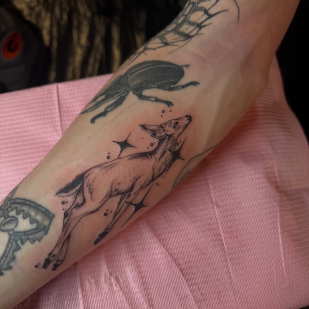 Deer and beetle black and grey tattoo on the forearm by Nina Nichole