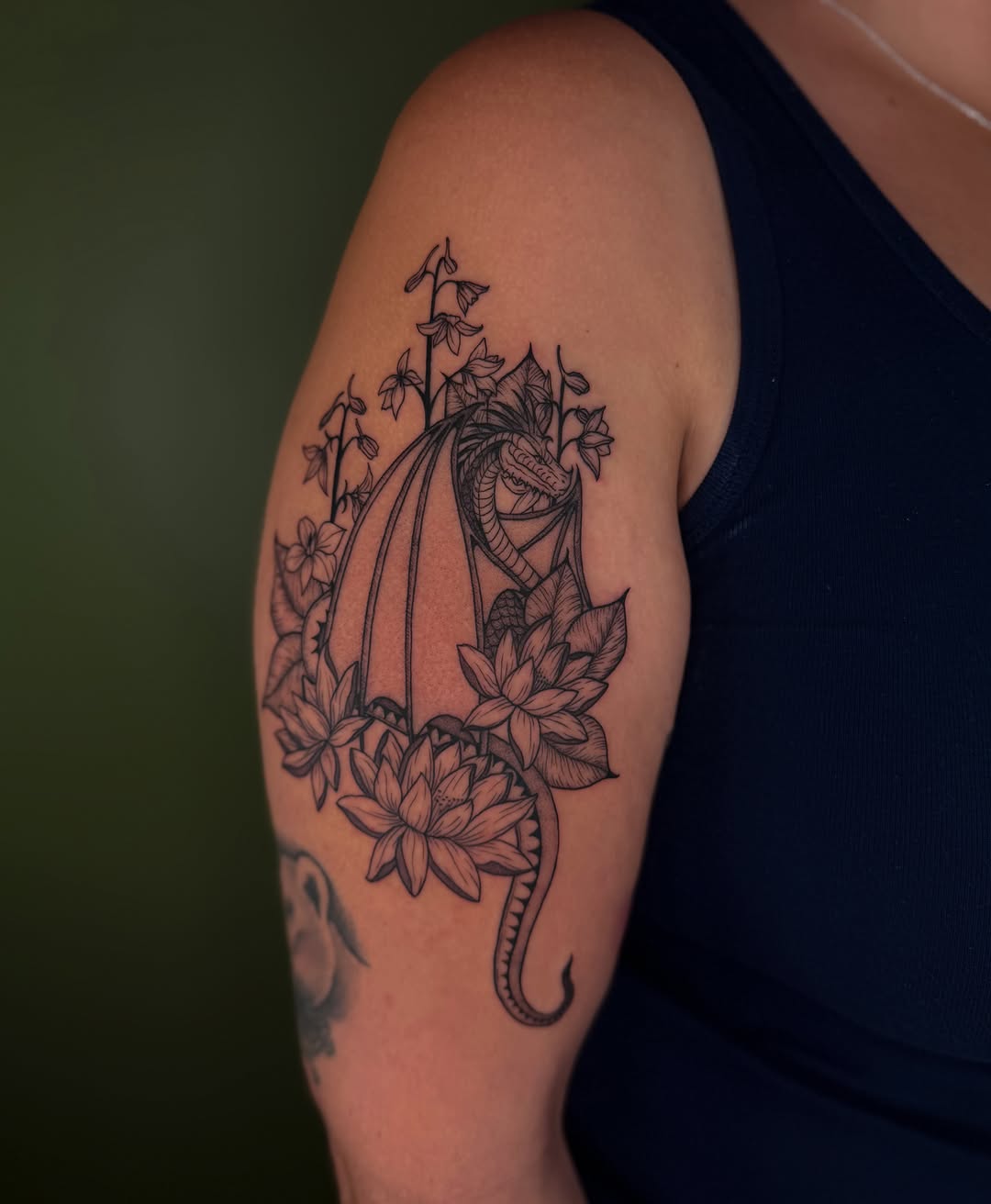Lotus and dragon black and grey tattoo on the upper arm by ๐ฅ ๐๐ฅ๐๐ฑ๐ข๐ฌ ๐ฅ