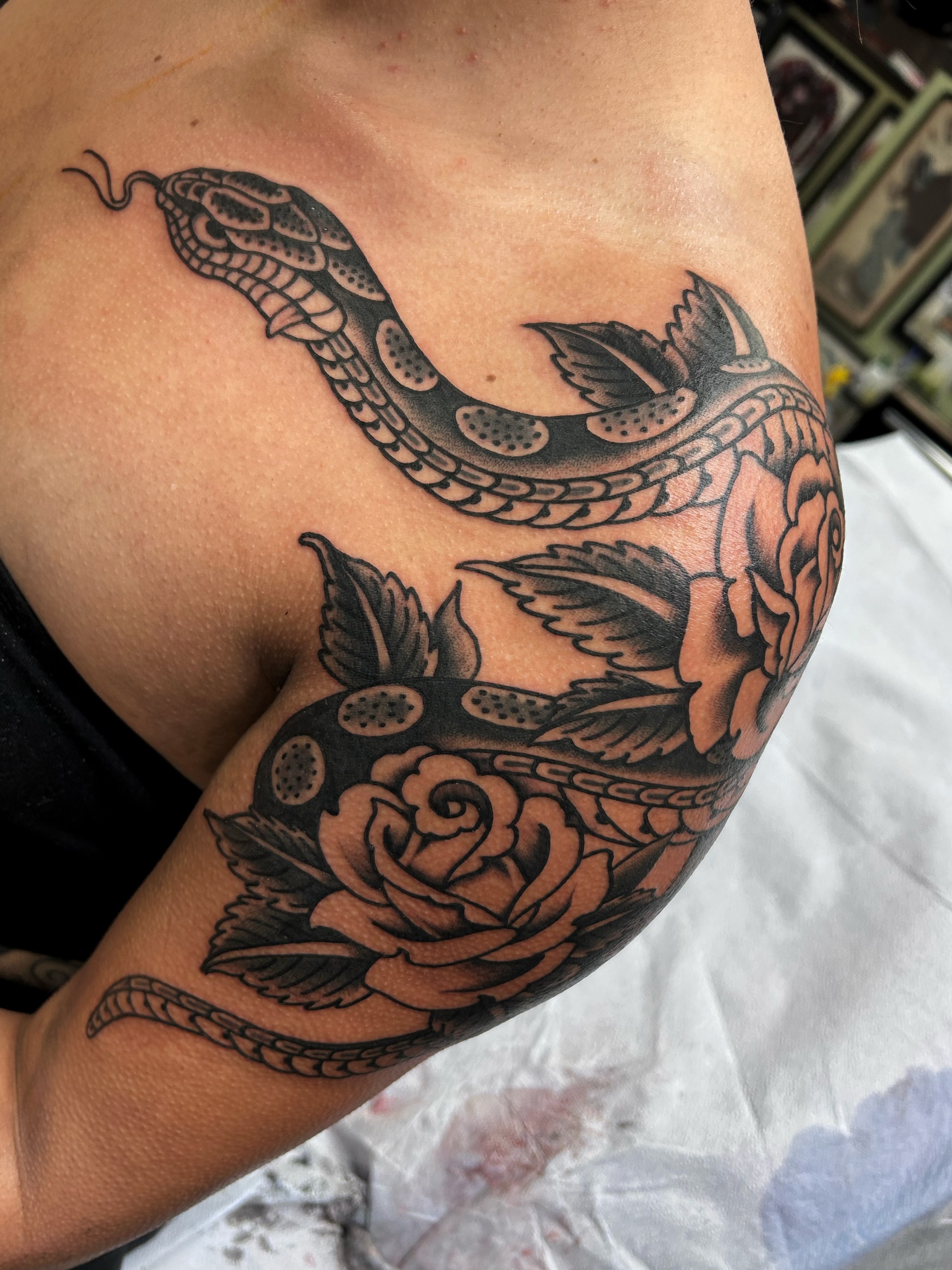 Snake and rose American traditional tattoo on the shoulder by Jade McKenzie, Temecula, California