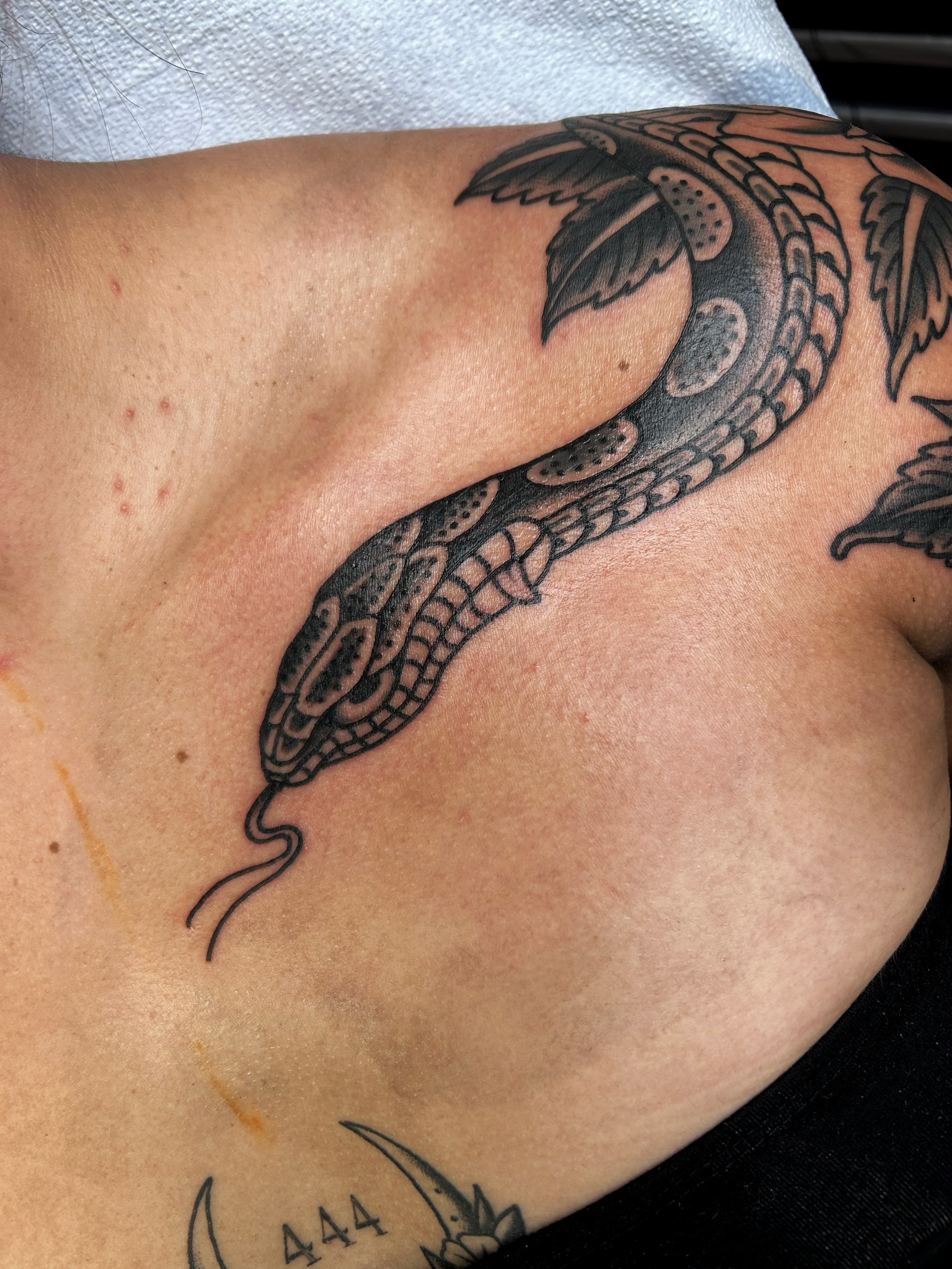 Snake black and grey tattoo on the shoulder by Jade McKenzie, Temecula, California