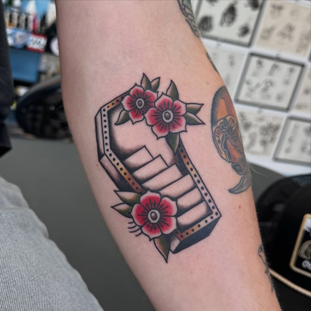 Geometric frame with flowers American traditional tattoo on the forearm by Béle Benard