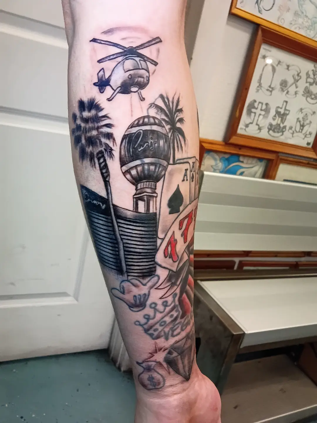 Helicopter, casino, palm trees American traditional tattoo on the forearm by Rando Rad