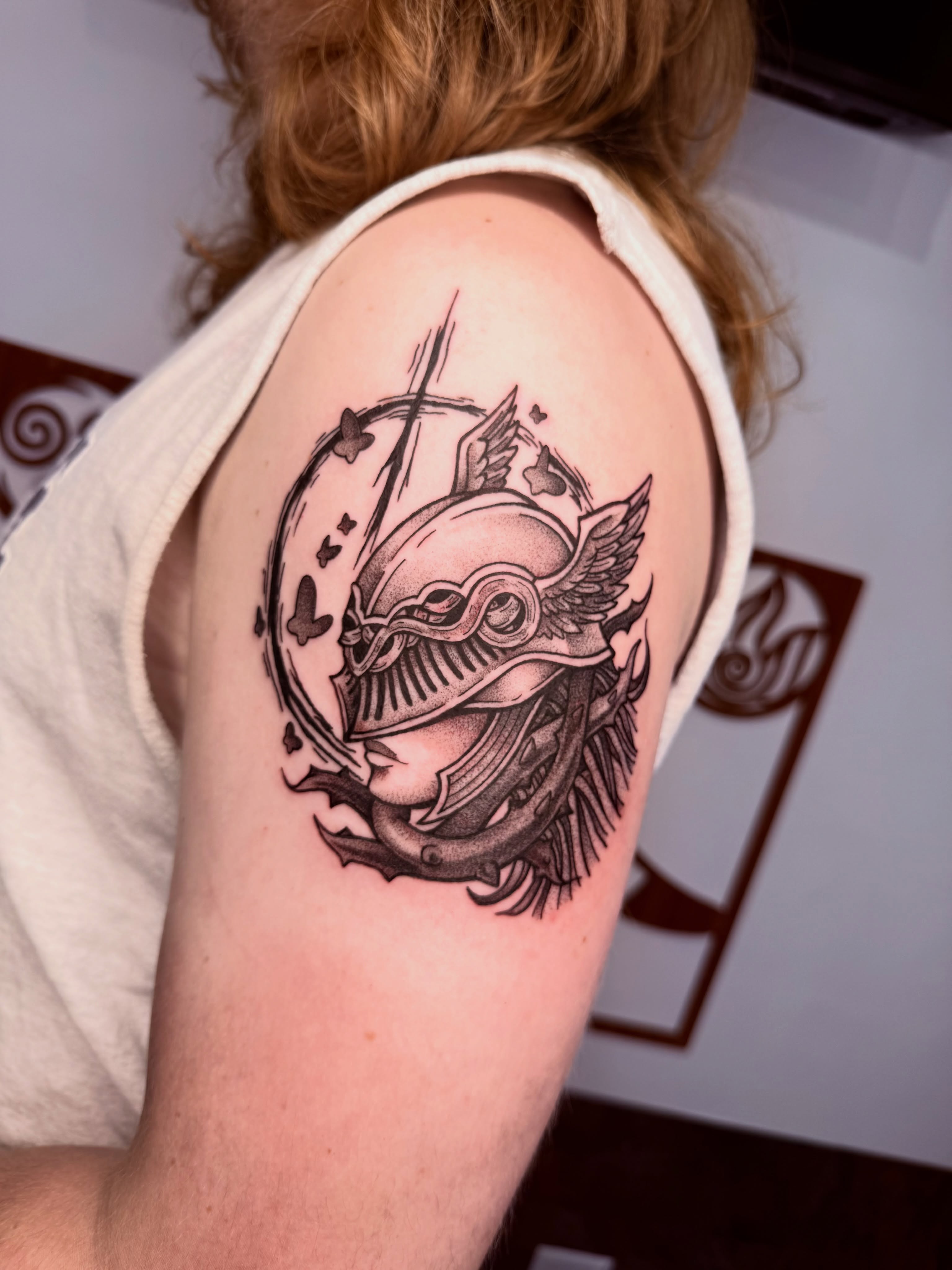 Helmeted warrior realism tattoo on the shoulder by Jezza Munson