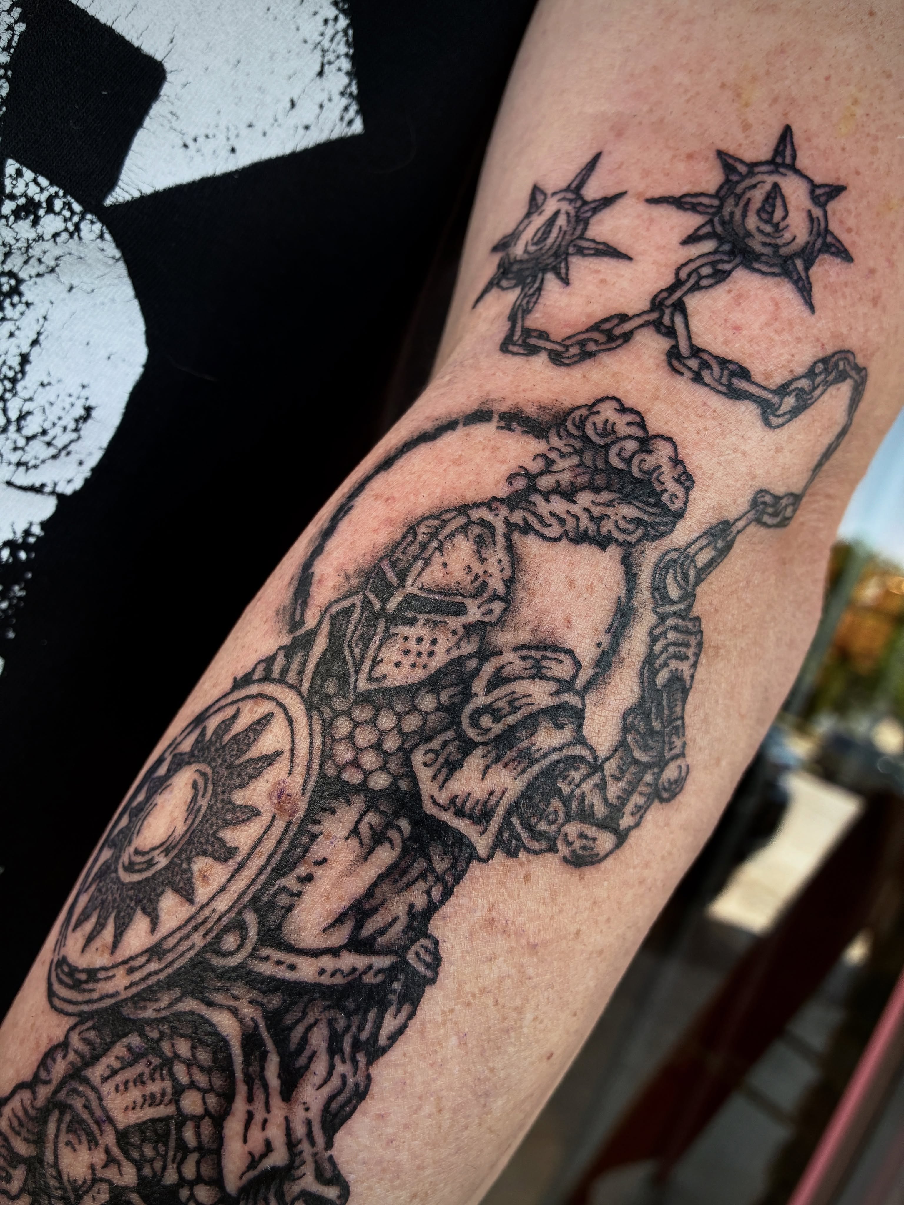 Warrior with shield and chain black and grey tattoo on the forearm by Zachary R Bobkoff