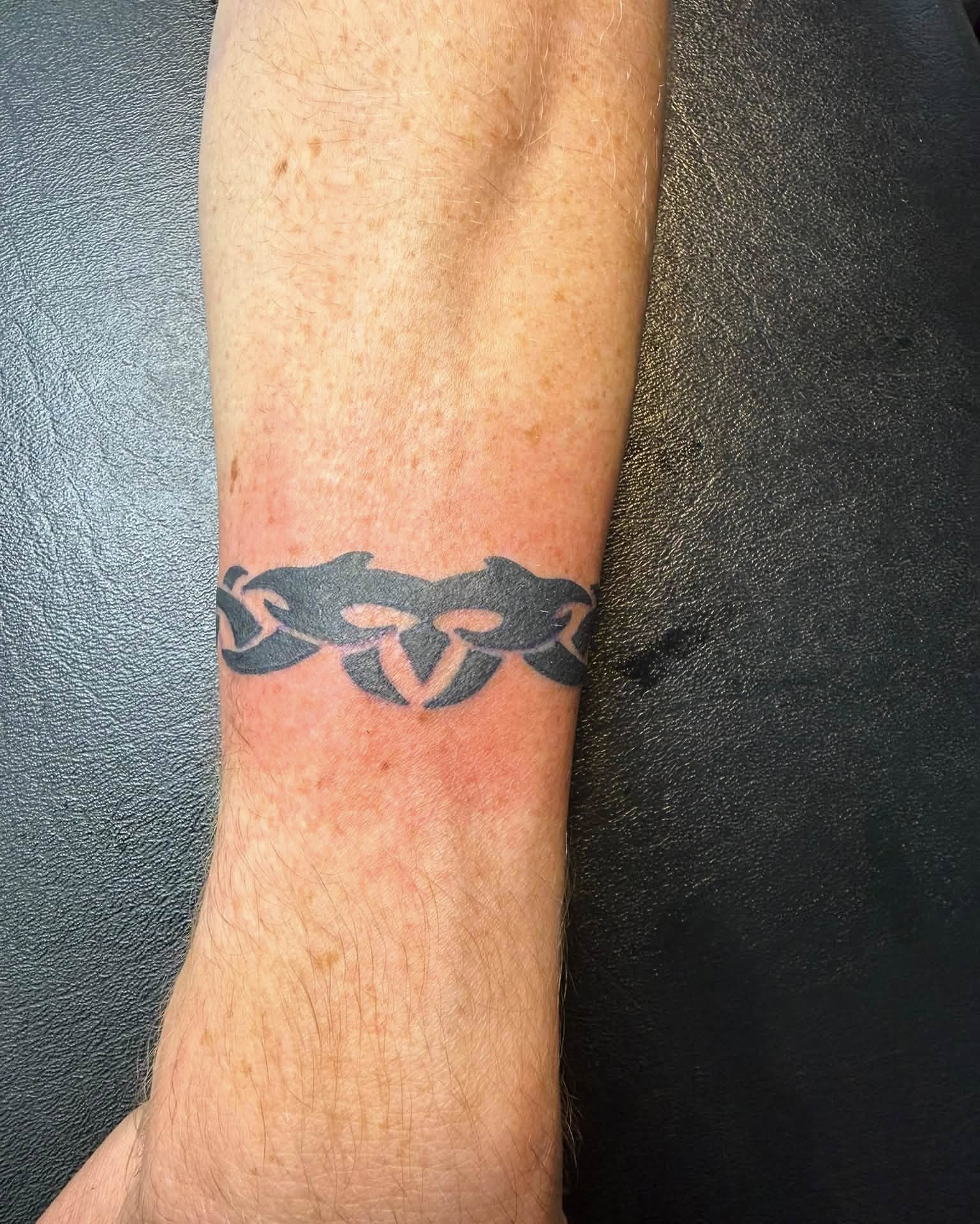 Mask black and grey tattoo on the forearm by @lady_raven_tattoo