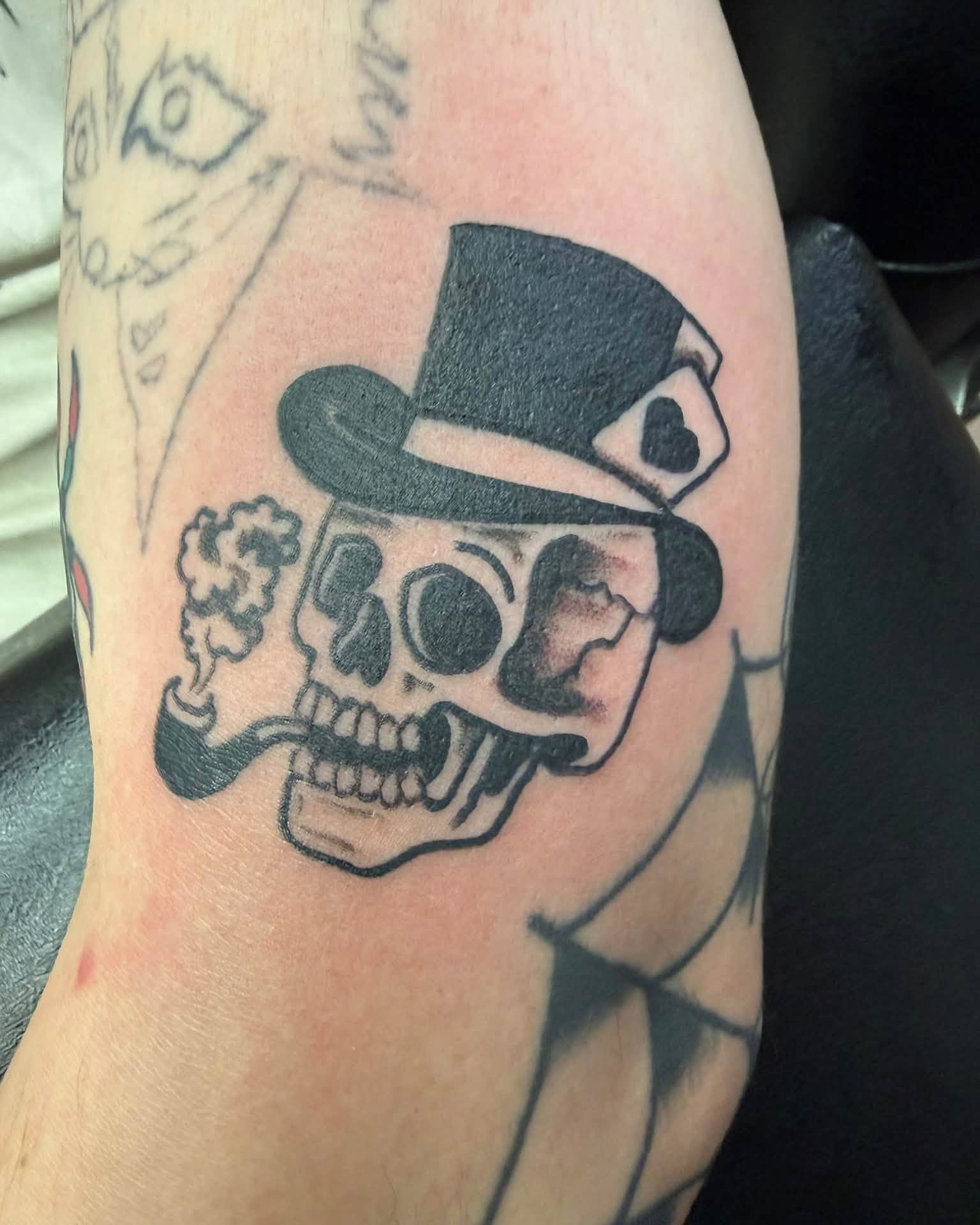 Skull wearing top hat black and grey tattoo on the forearm by @lady_raven_tattoo