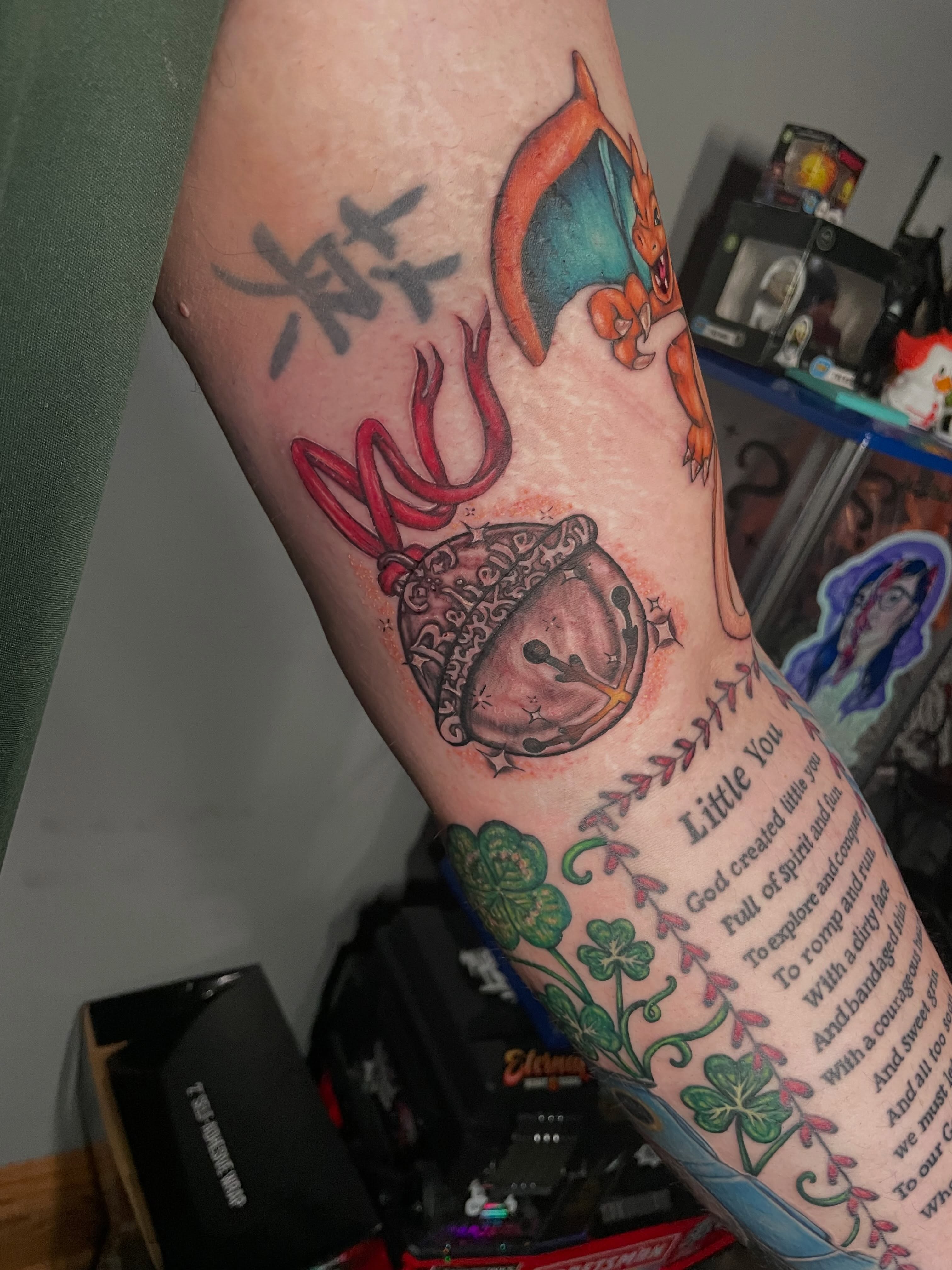 Dragon and bell anime tattoo on the forearm by Hannah Copeskey