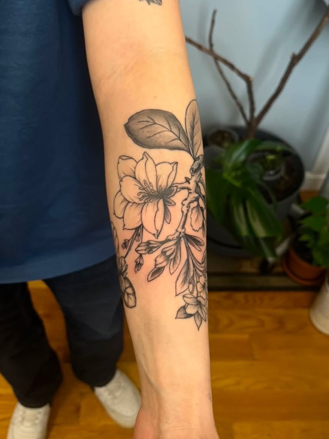 Cherry blossoms black and grey tattoo on the forearm by Garden Glow Tattoo