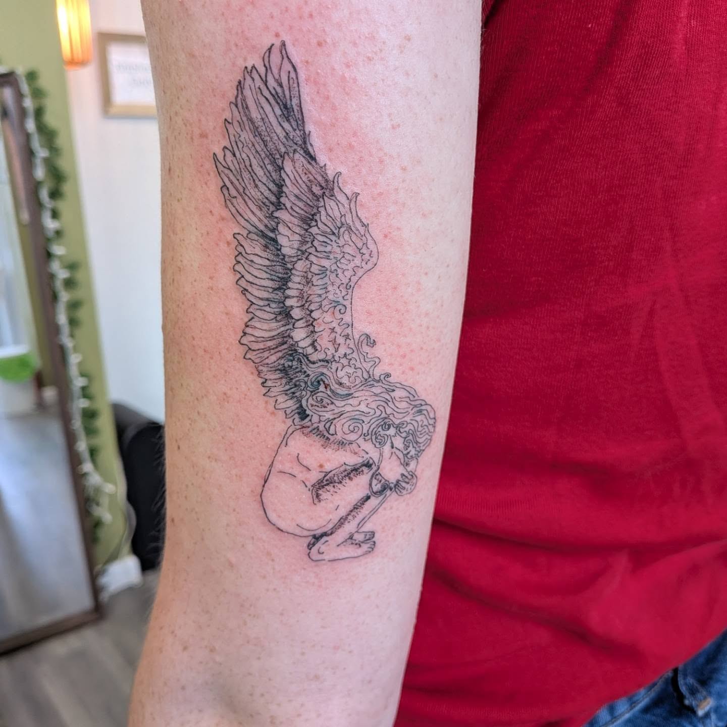 Winged angel black and grey tattoo on the forearm by Ryan