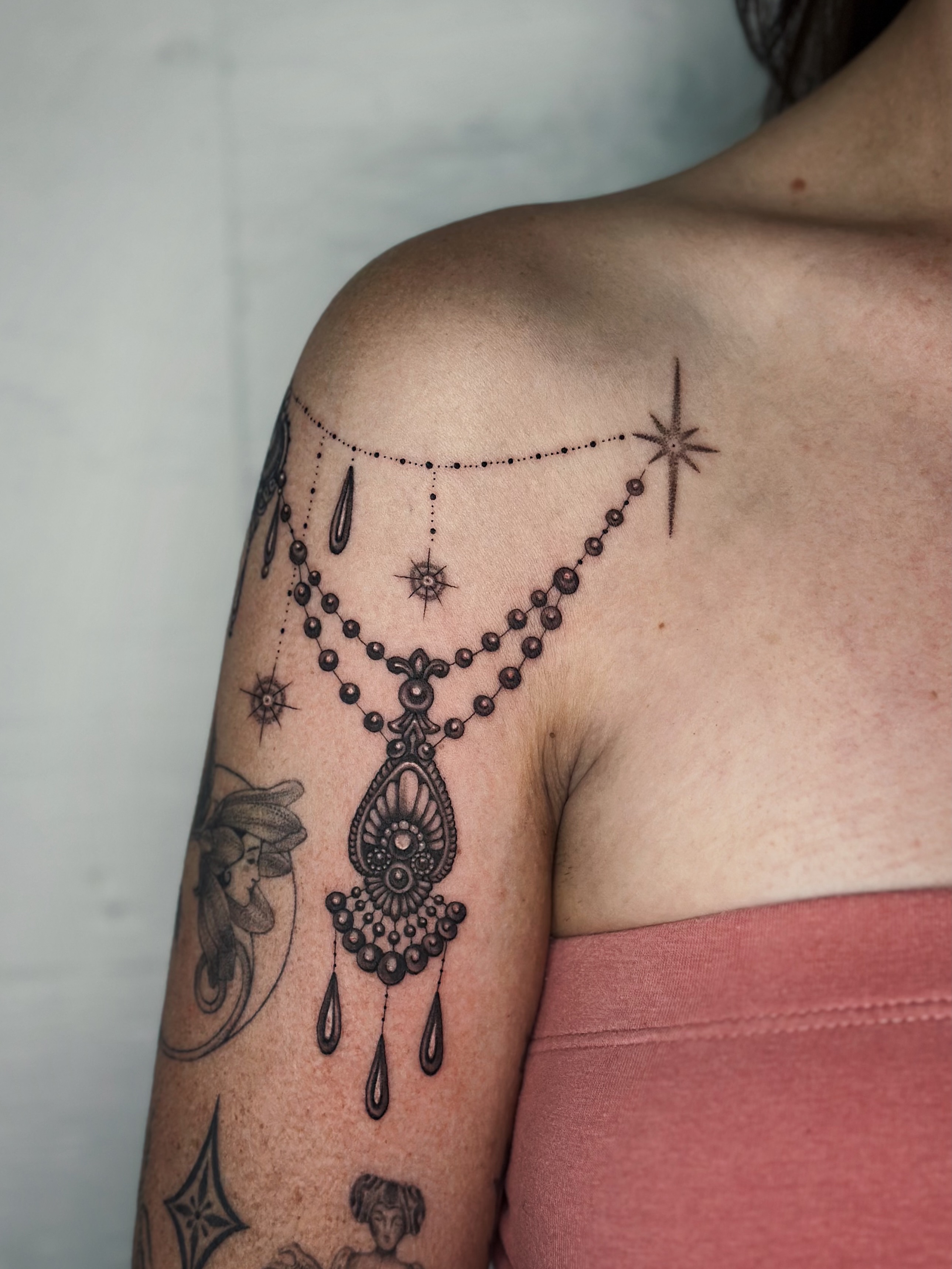 Necklace ornamental tattoo on the shoulder by Lauryn Jenesis