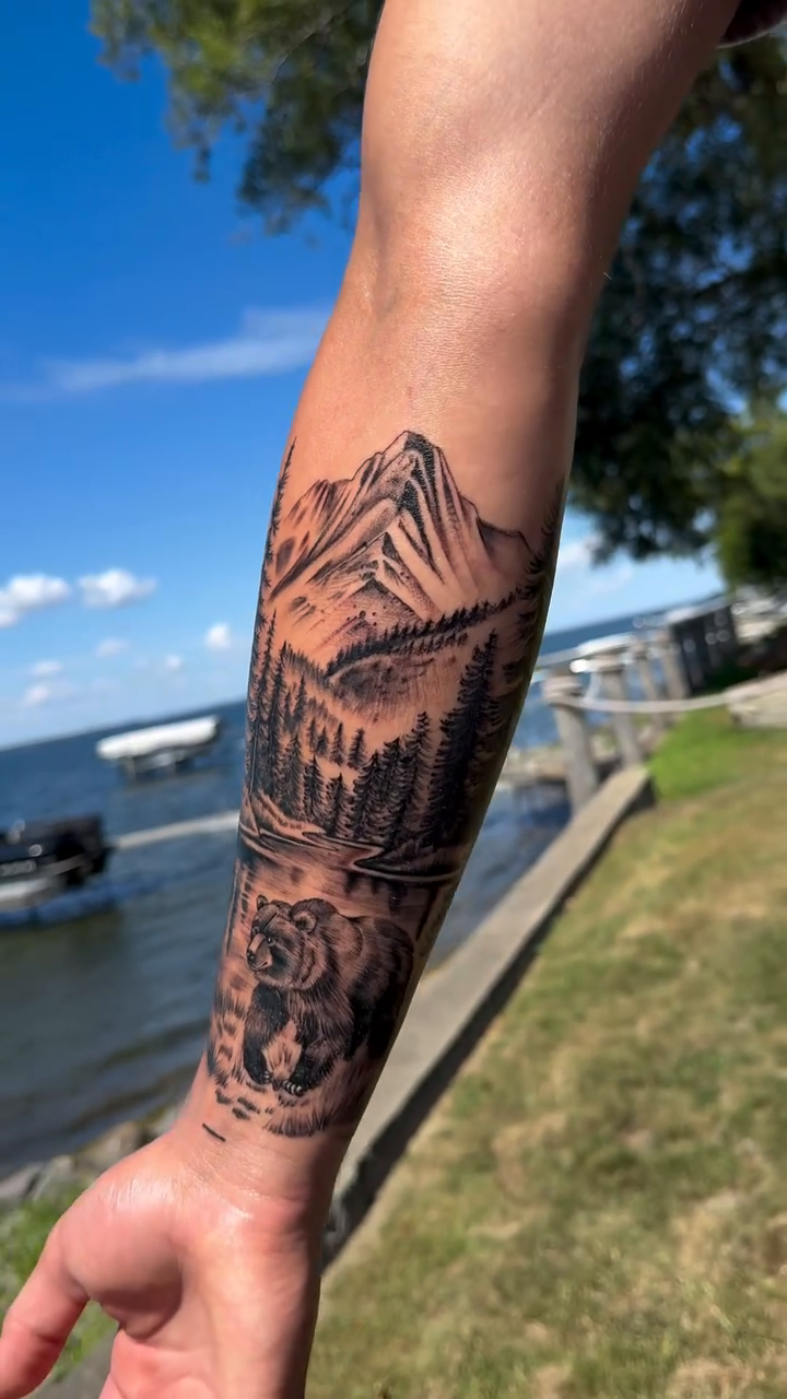 Mountain landscape with bear and trees realism tattoo by Licensed Tattoo Artist πΈπ»