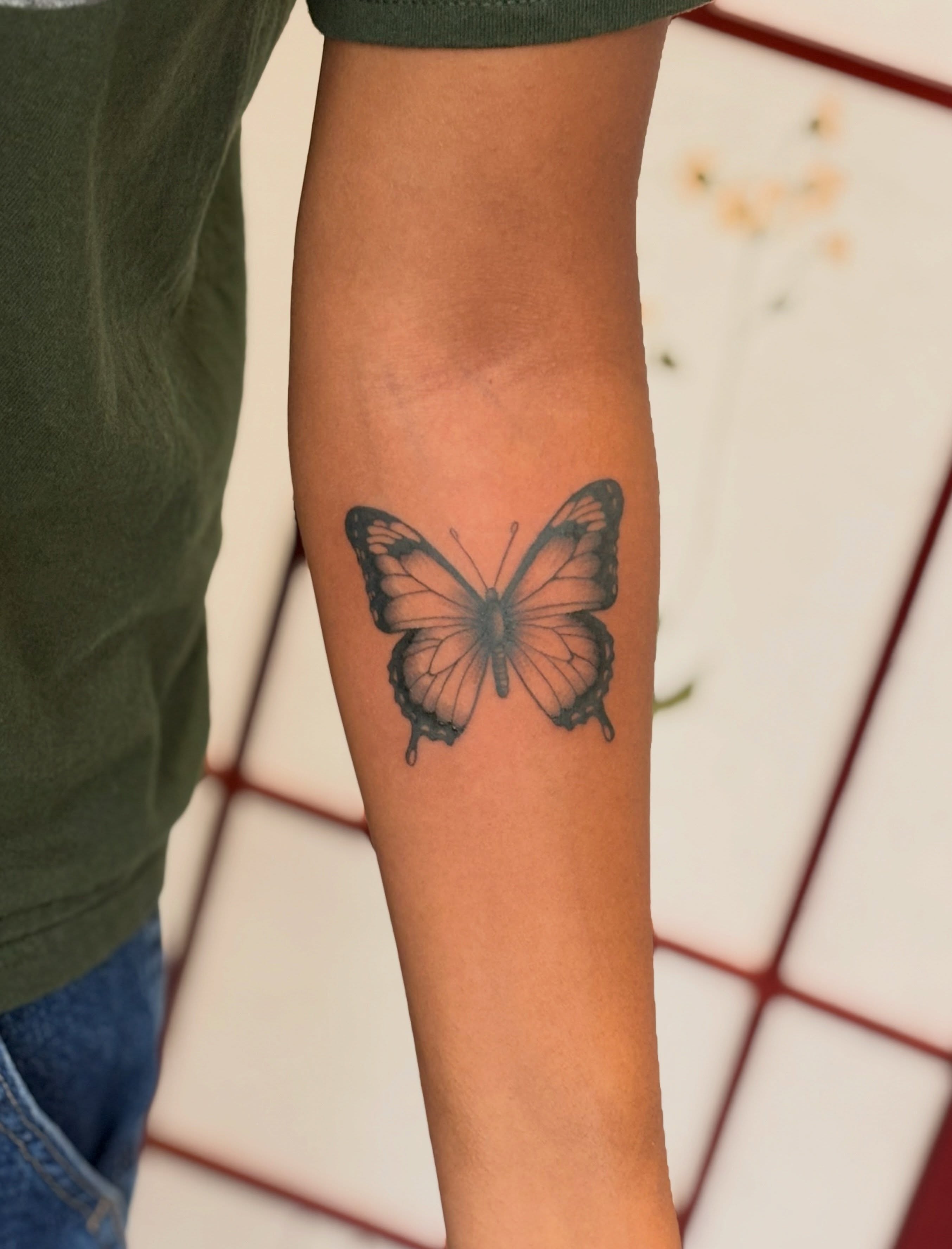 Butterfly black and grey tattoo on the forearm by CJ