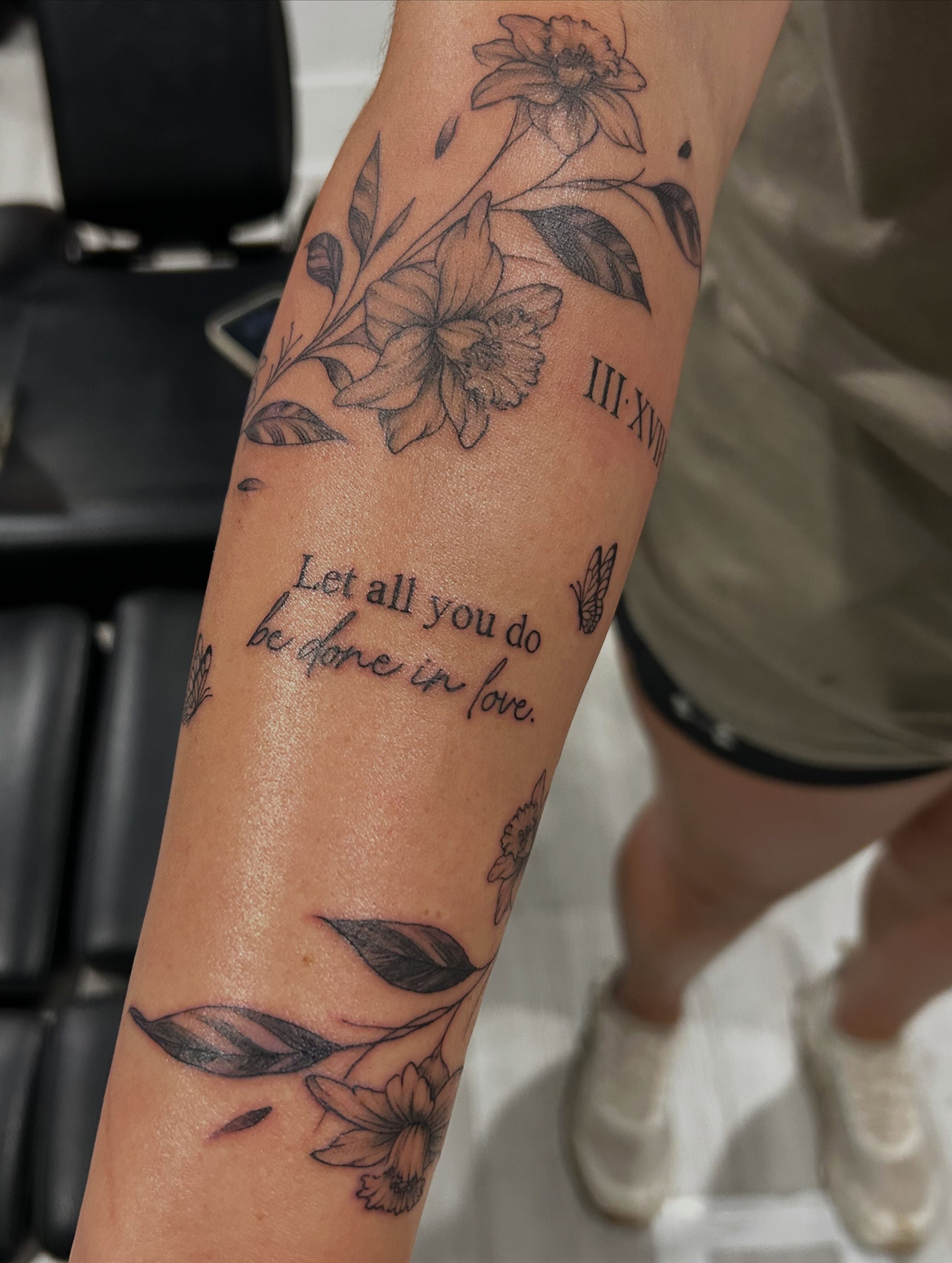 Flowers and leaves black and grey tattoo on the forearm by Jbtattoo Artistry