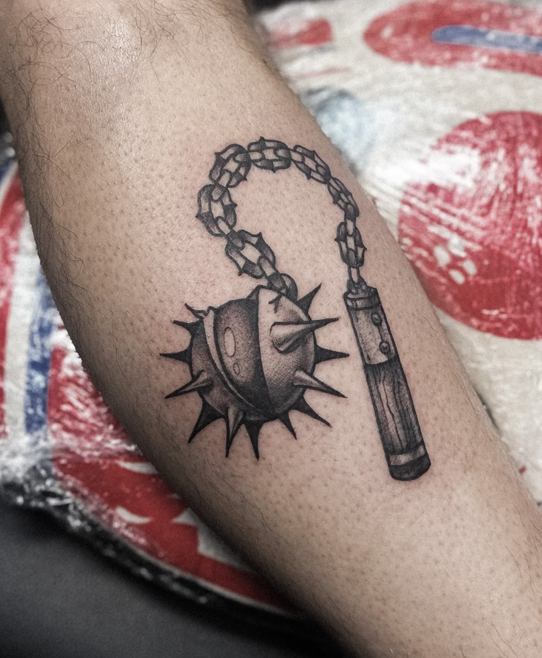 Ball and chain black and grey tattoo on the forearm by Elvira Savchuk
