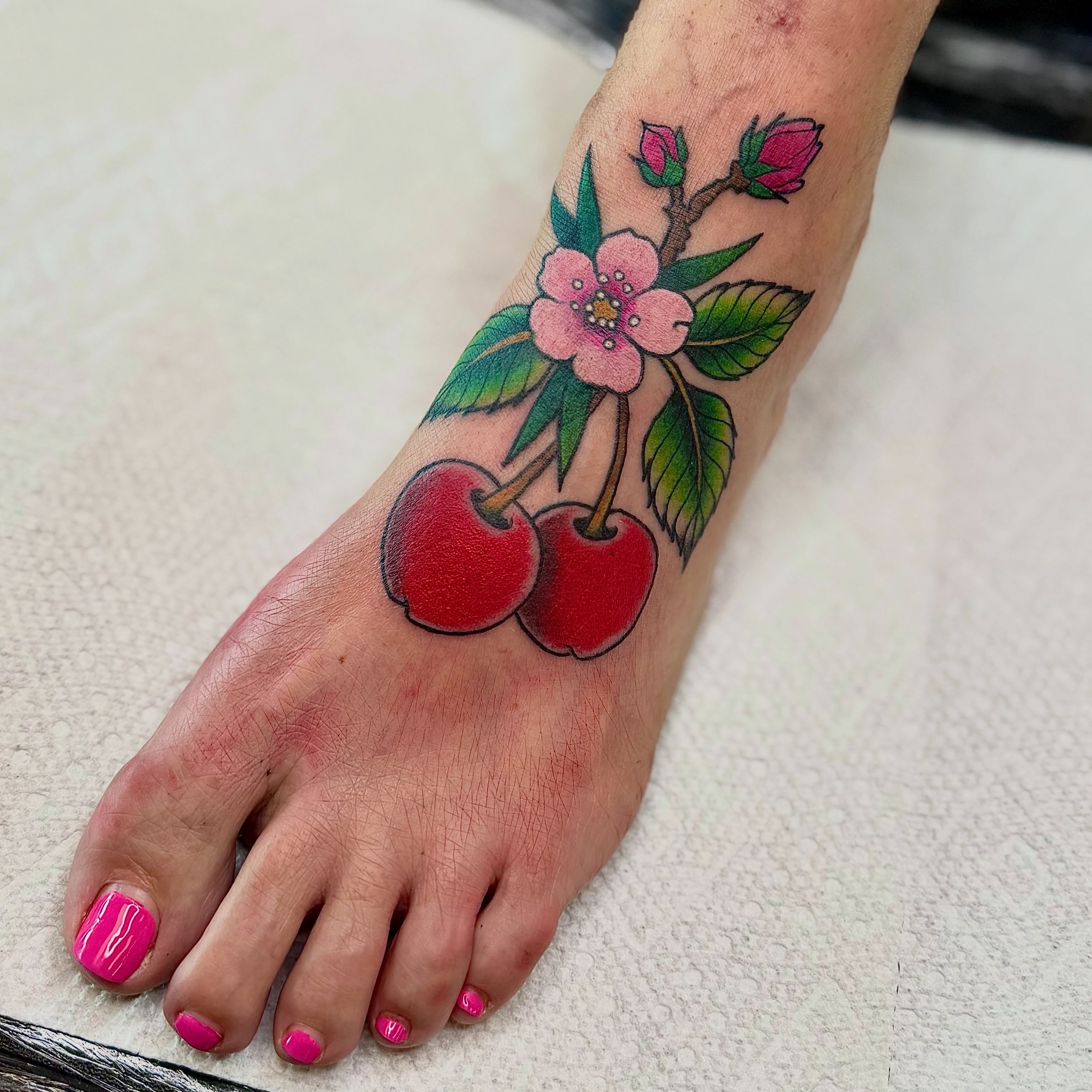 Cherry blossoms American traditional tattoo on the foot by Jamie Hall, Kansas City, Missouri
