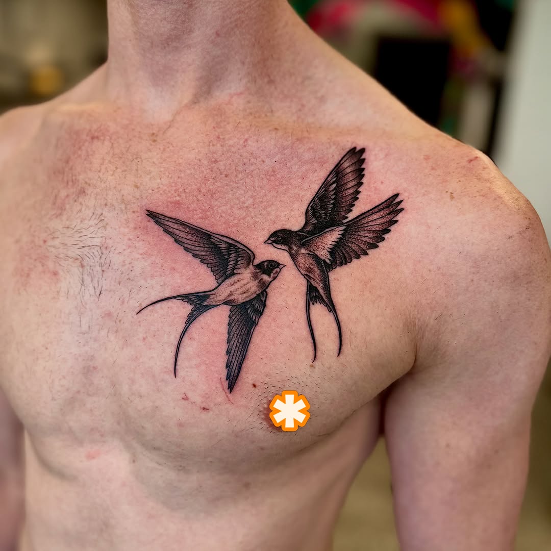 Swallows black and grey tattoo on the chest by Jamie Hall, Kansas City, Missouri