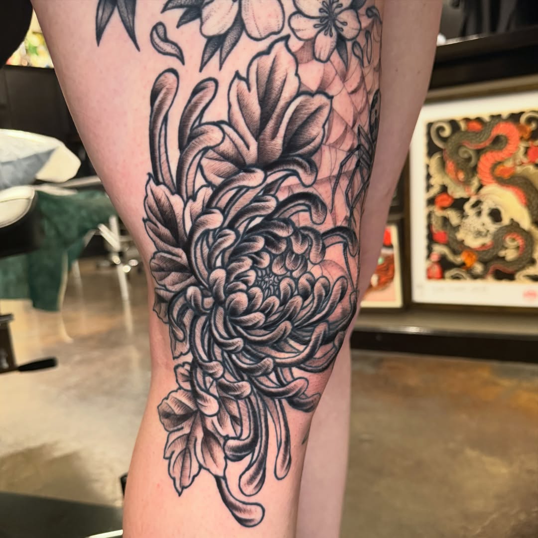Chrysanthemum black and grey tattoo on the calf by Christopher Mikesell