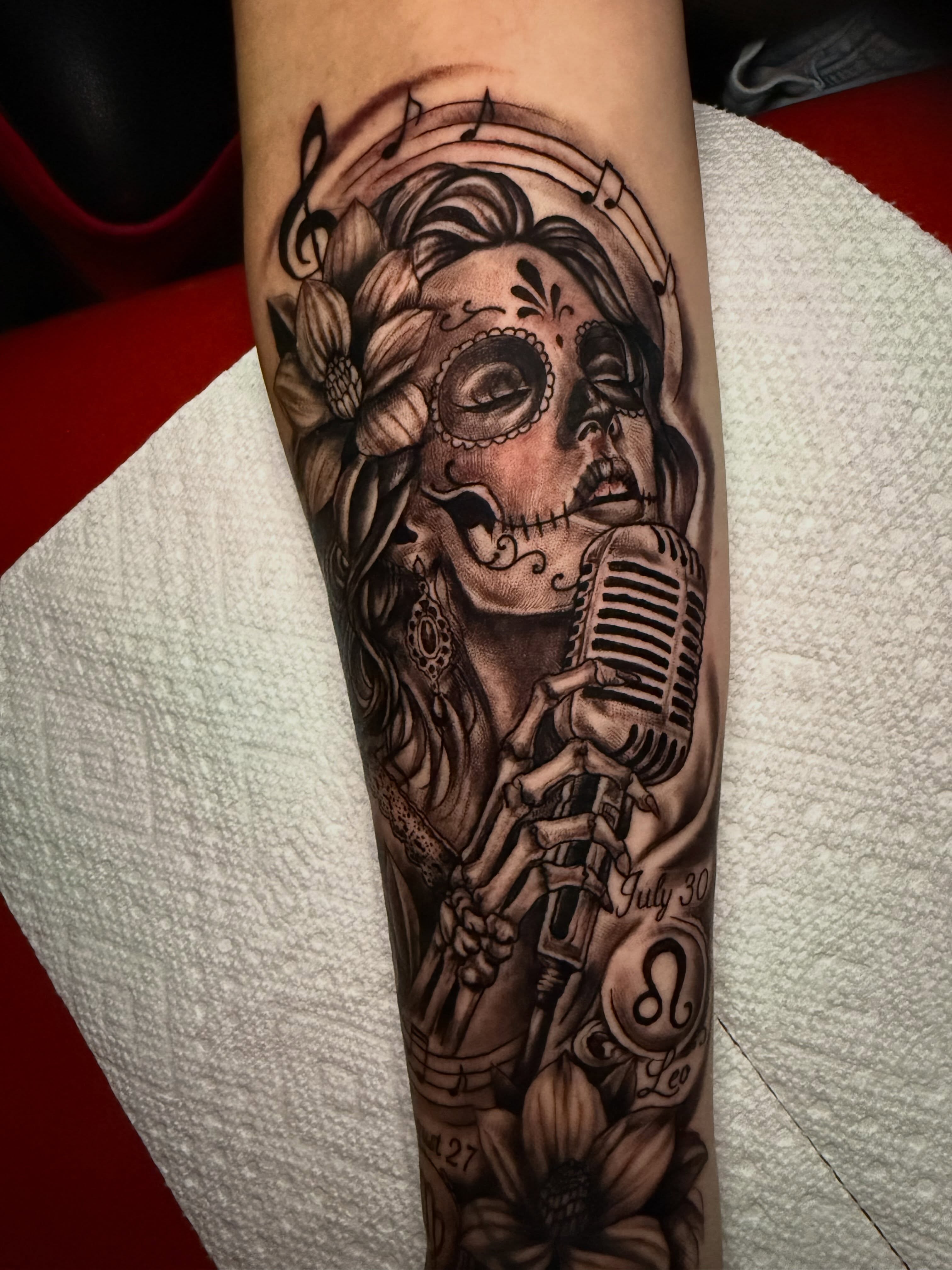 Sugar skull singer realism tattoo on the forearm by Lucky Valenzuela, Lakewood, Colorado