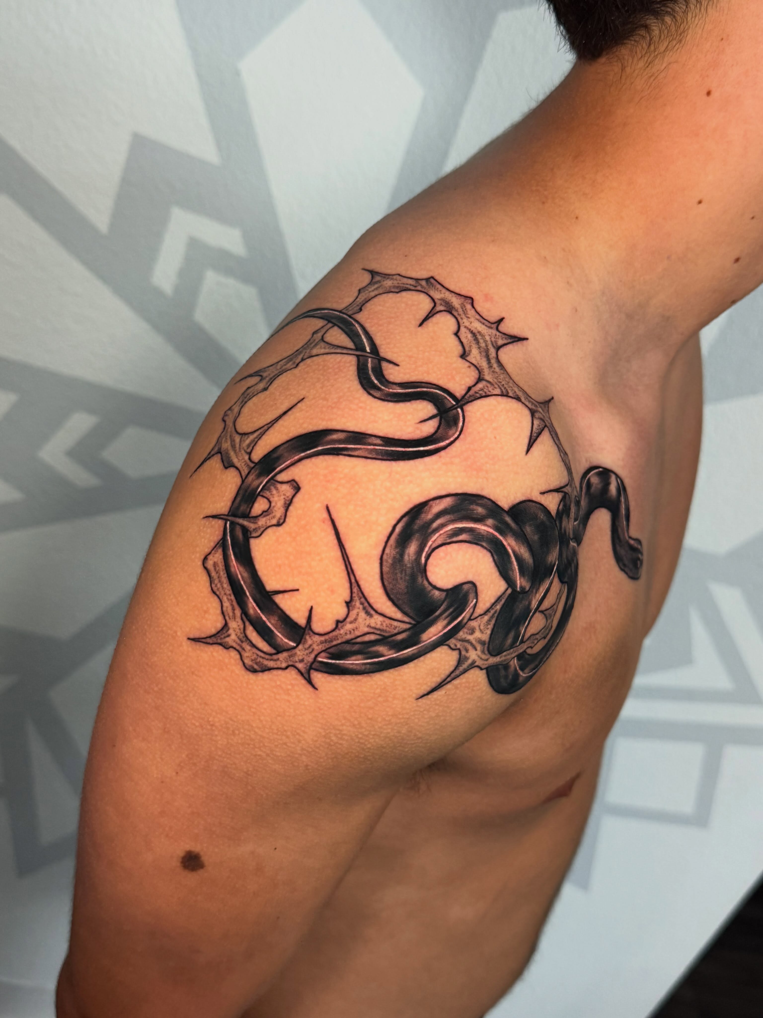 Snake and thorns black and grey tattoo on the shoulder by Las Vegas Tattoo Artist, Las Vegas, Nevada