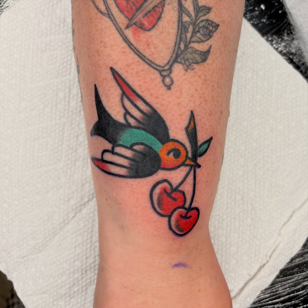 Bird and cherries American traditional tattoo on the forearm by Braedon 🎱