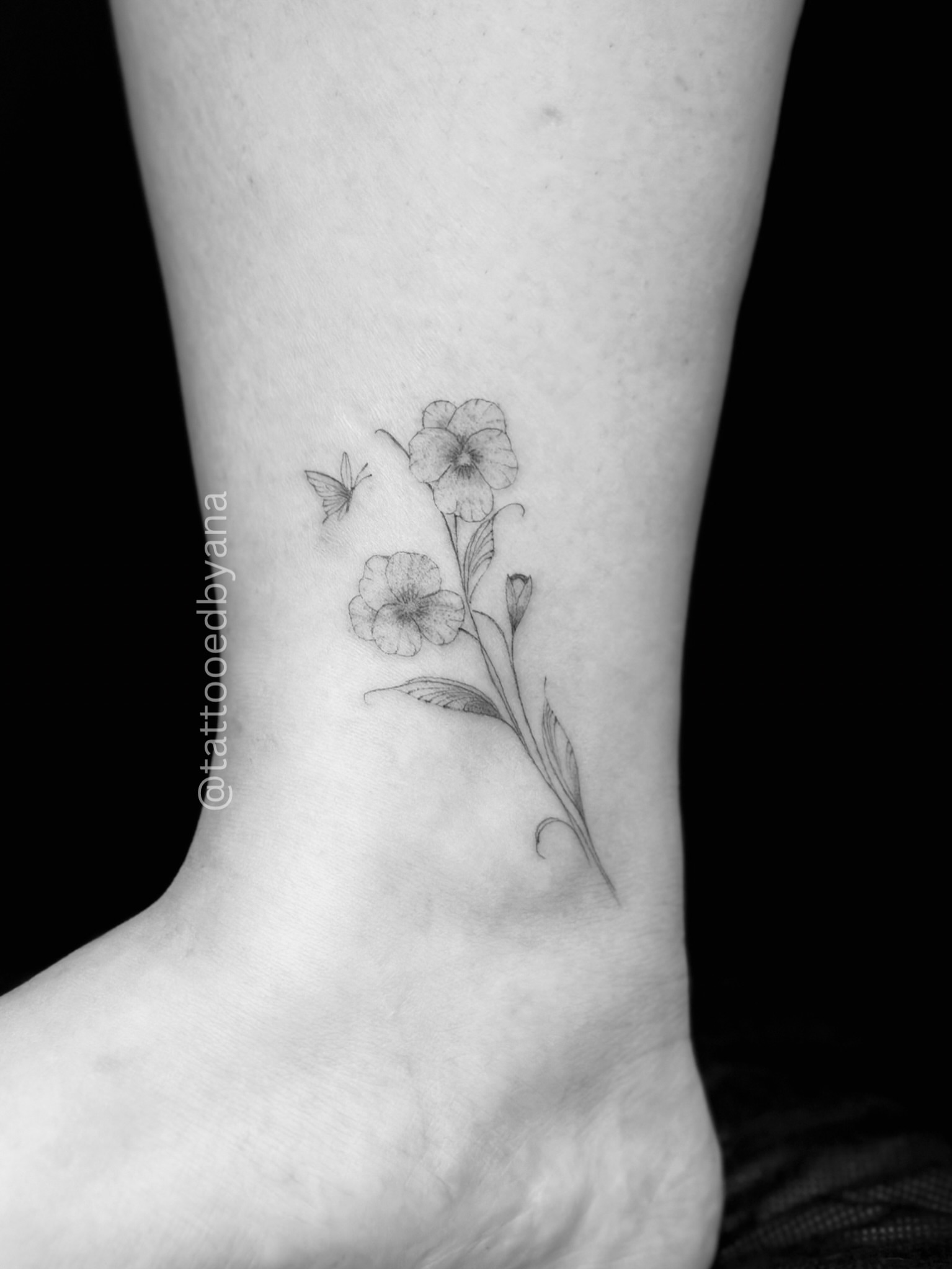 Flowers and butterfly realism tattoo on the foot by Tattoo artist Denver
