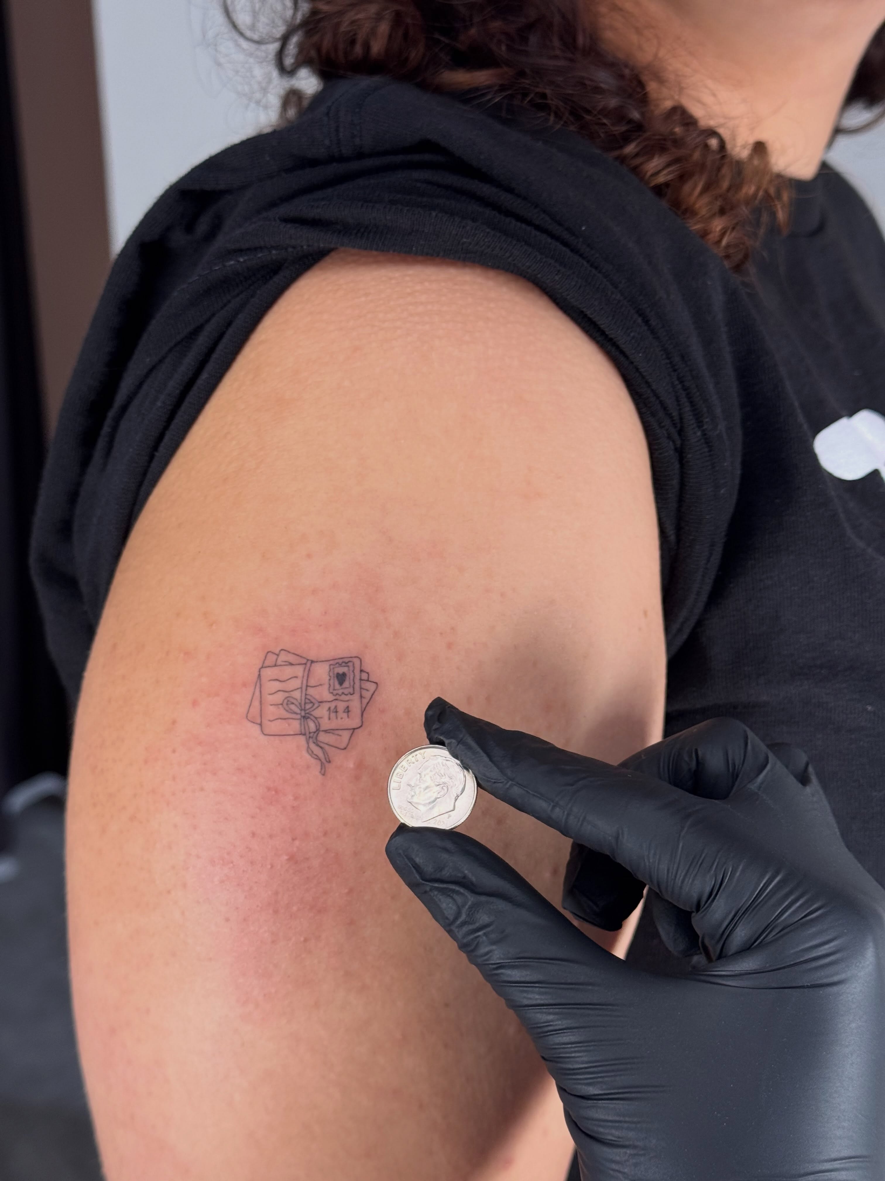 Book black and grey tattoo on the shoulder by Danae Andino