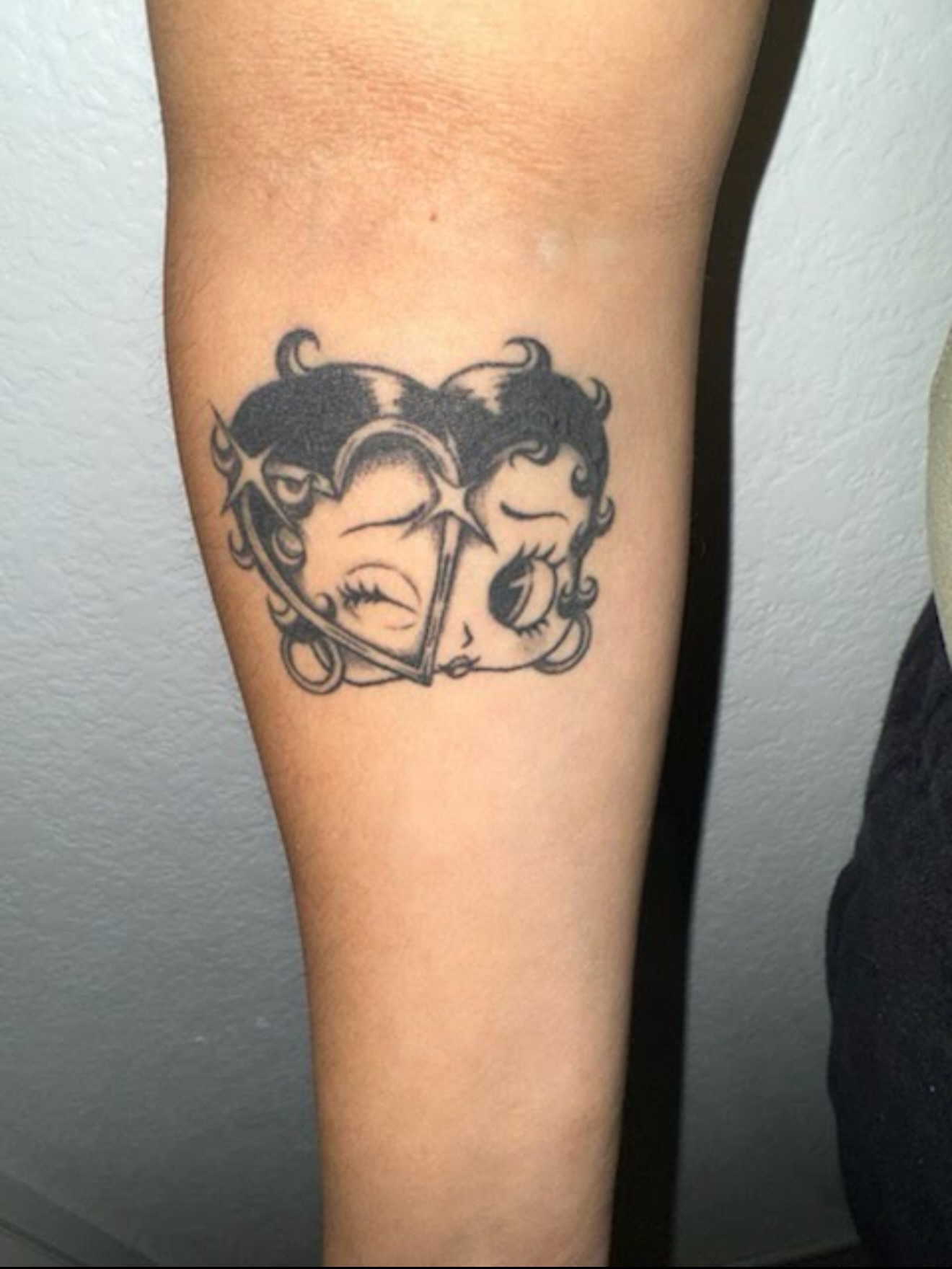 Female faces black and grey tattoo on the forearm by tattoo artist (mollz)