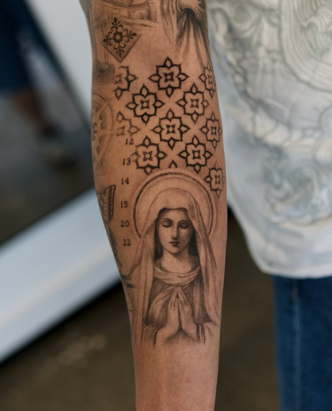 Religious figure realism tattoo on the forearm by Ray Quinday