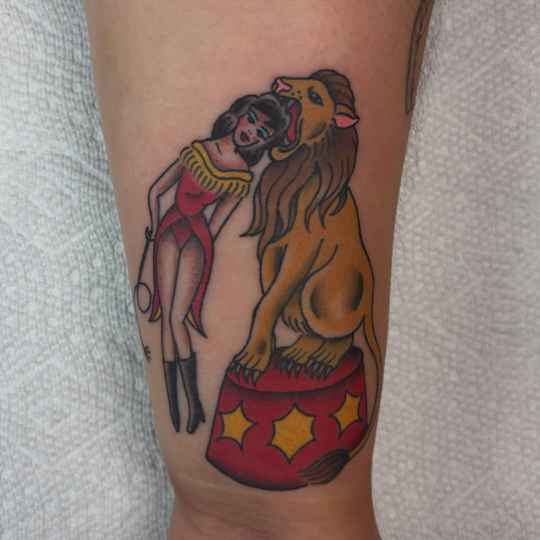 Lion tamer American traditional tattoo on the forearm by Juliet Miller