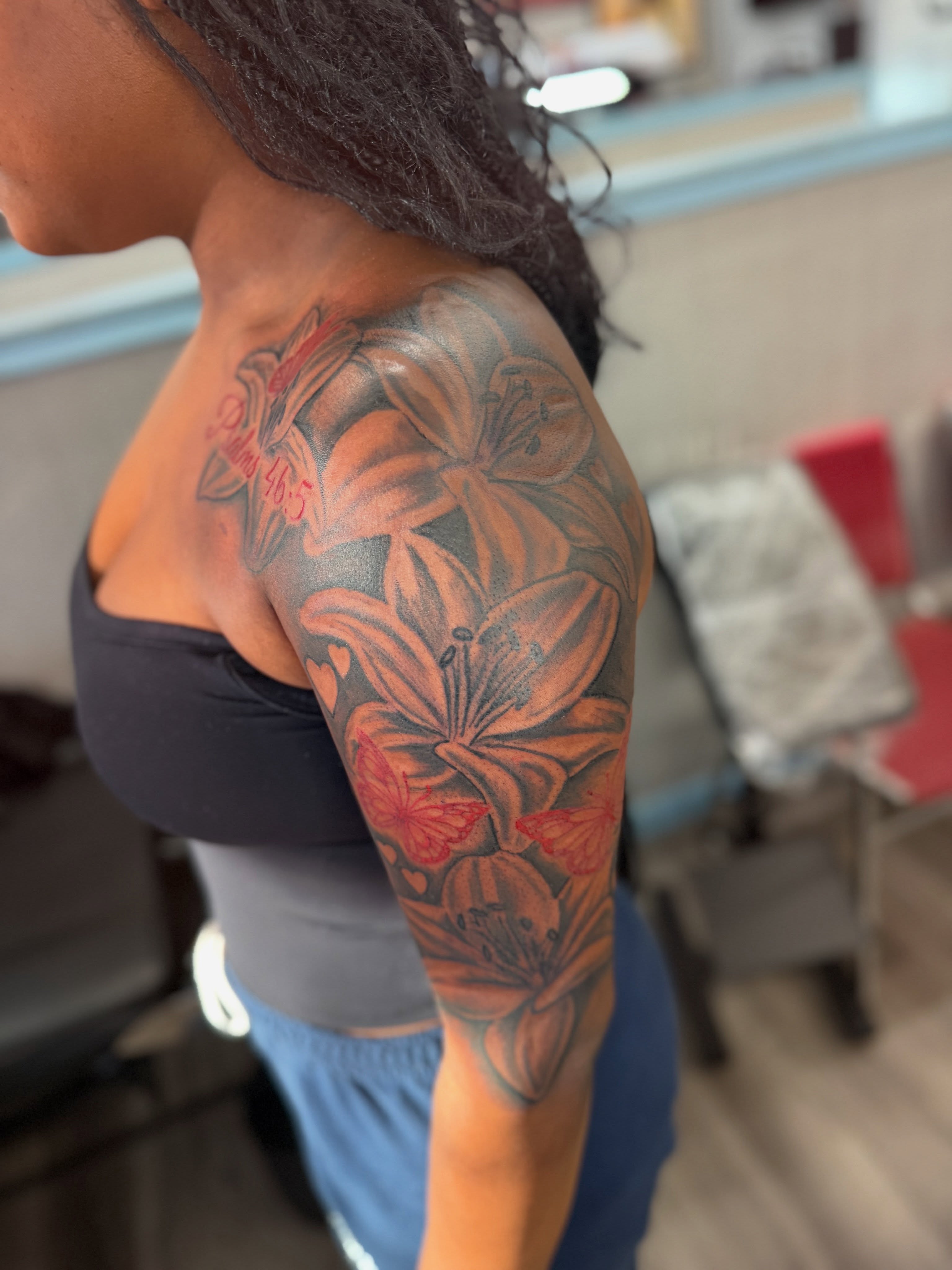 Lilies realism tattoo on the upper arm by JAE, Shreveport, Louisiana
