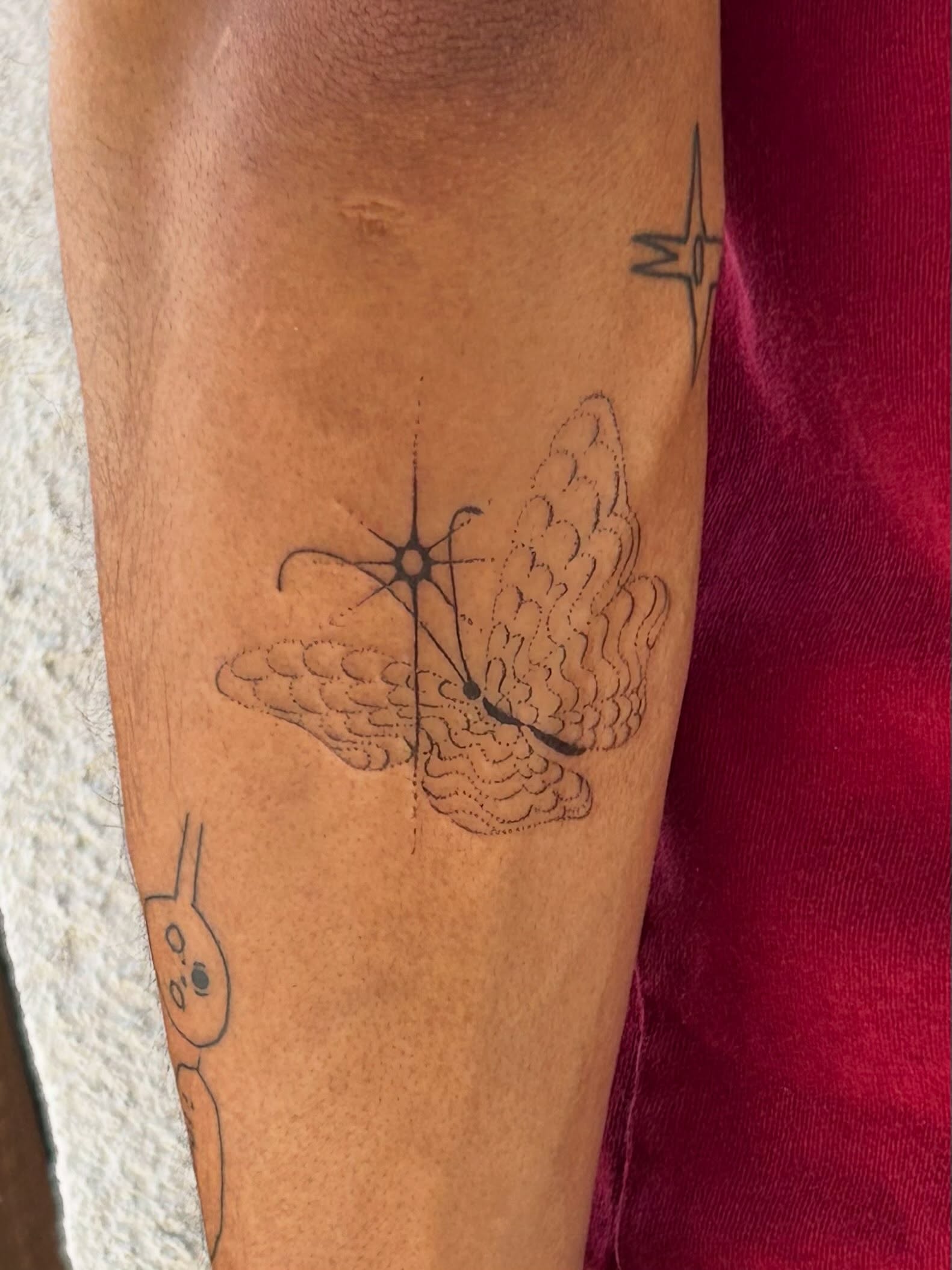 Butterfly geometric tattoo on the forearm by Nicolette