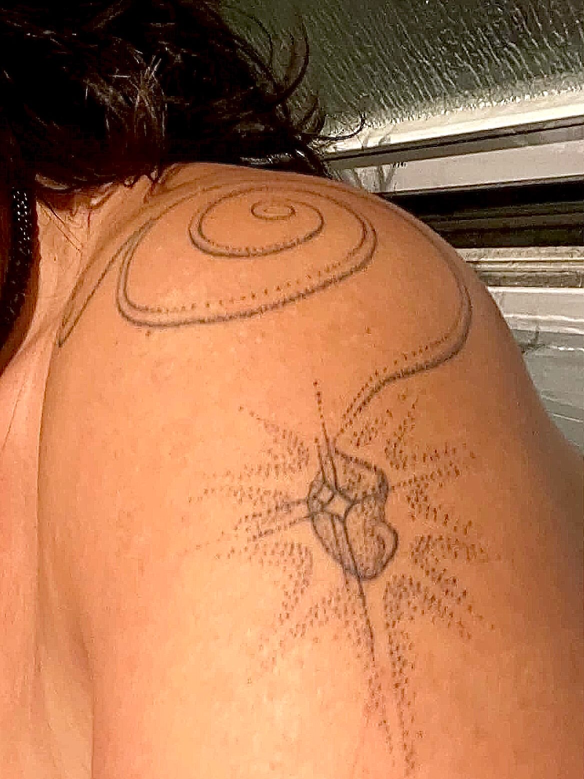 Geometric design dotwork tattoo on the shoulder by Nicolette