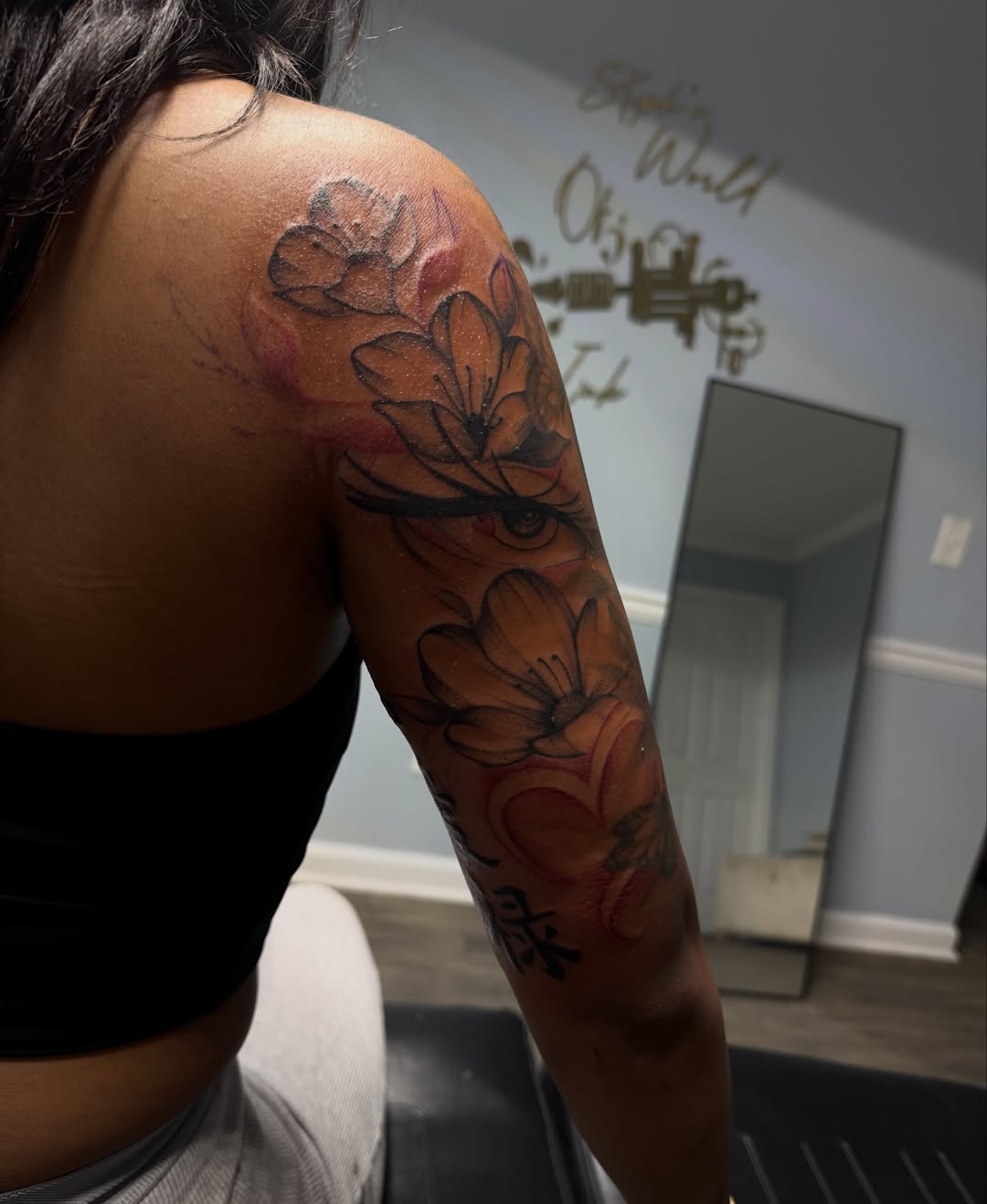 Floral arrangement watercolor tattoo on the upper arm by Stephania ATLANTA TATTOO ARTIST🎨