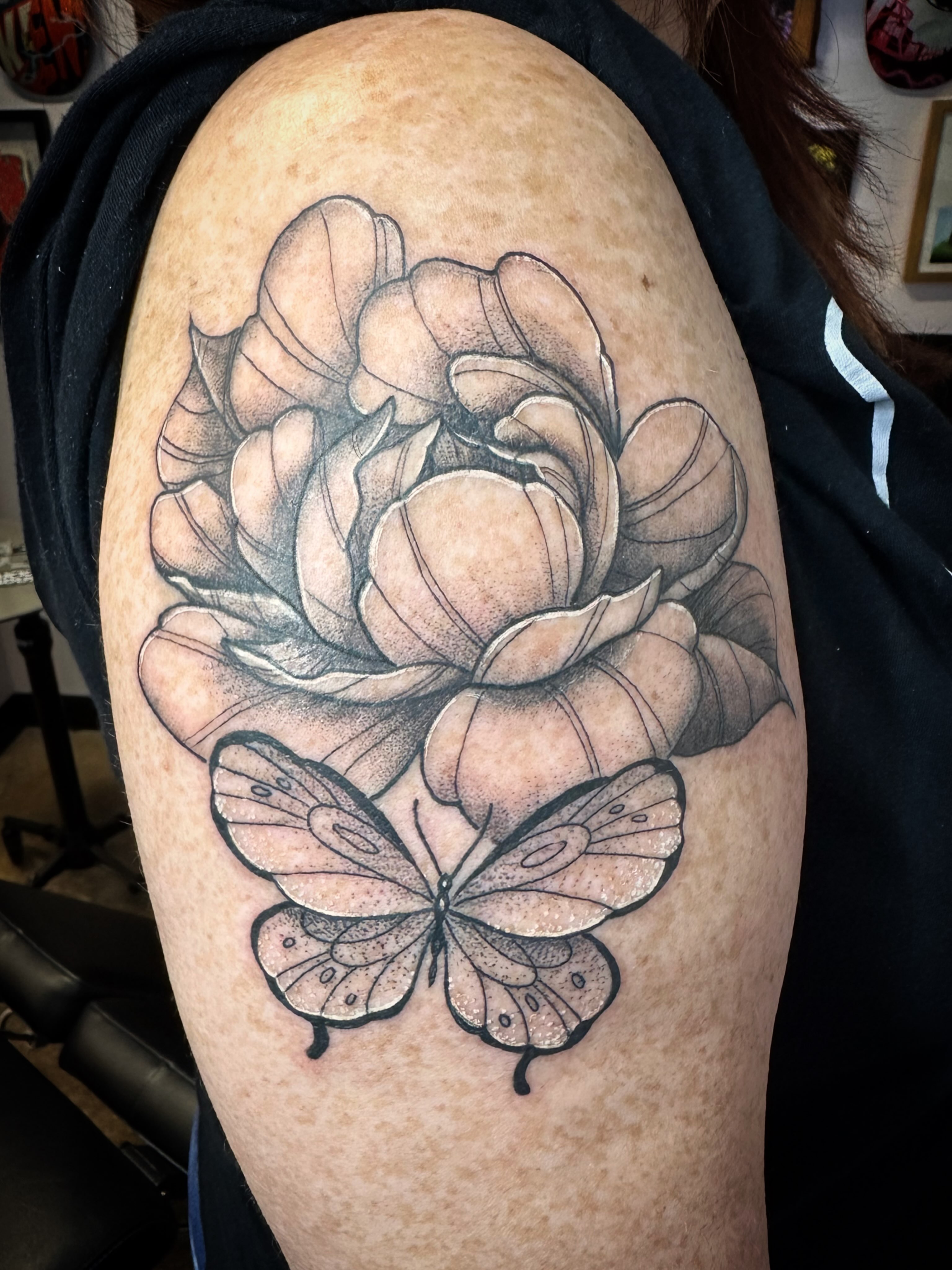 Peony and butterfly realism tattoo on the shoulder by Chris Gray