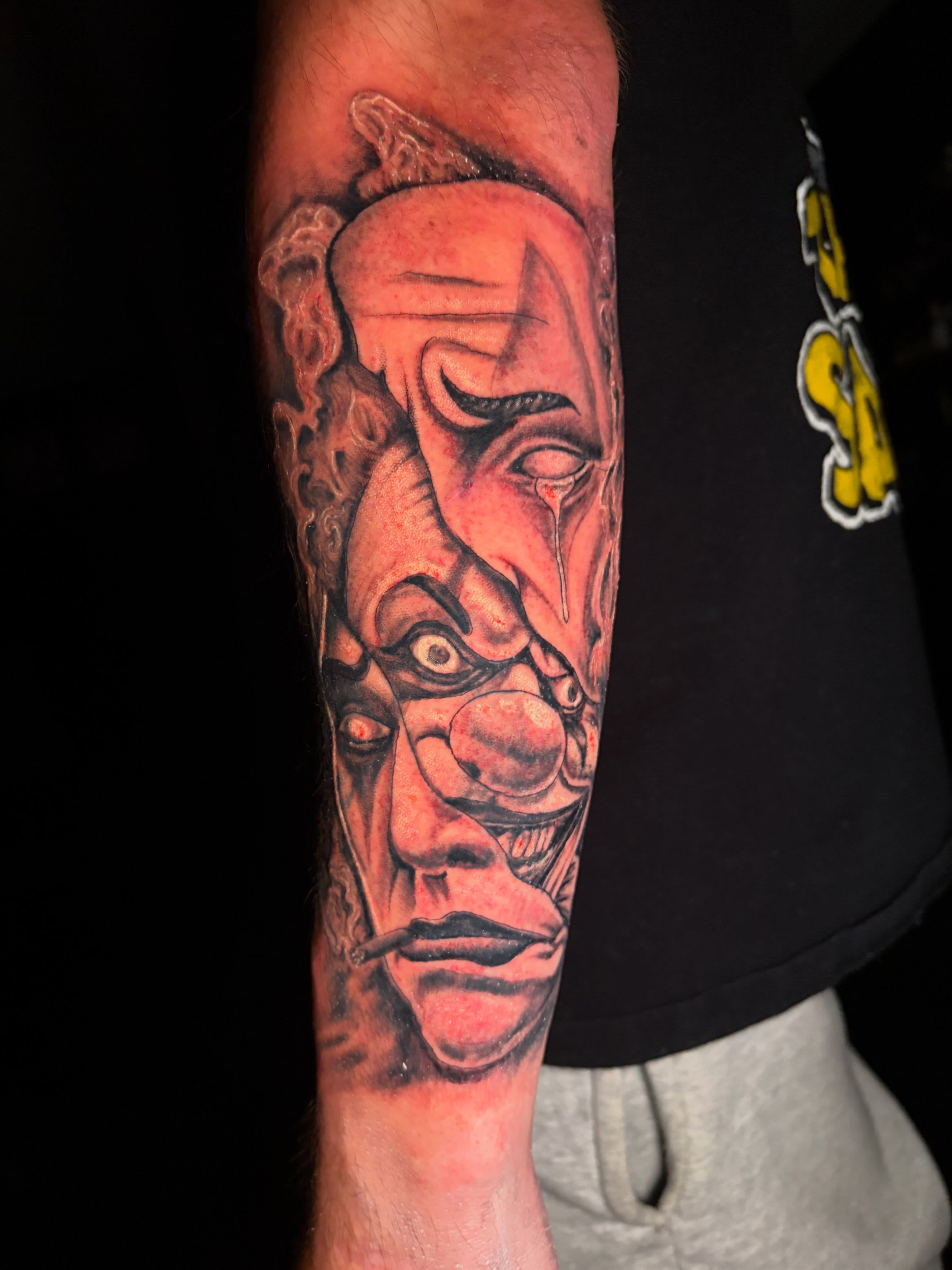 Abstract faces realism tattoo on the forearm by Fredrick Tigerman