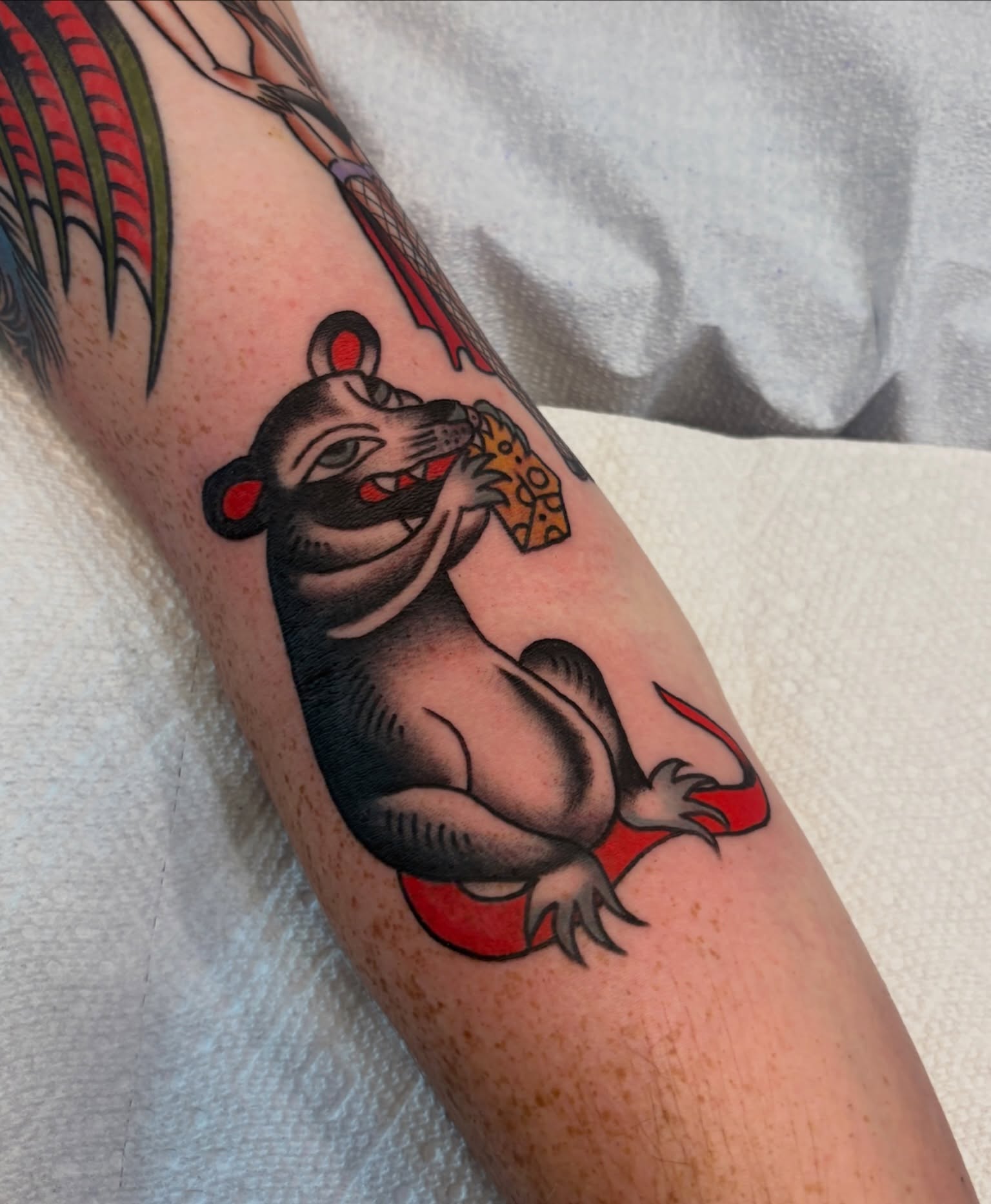 Rat eating cheese American traditional tattoo on the forearm by Sammy Tattoo, Austin, Texas