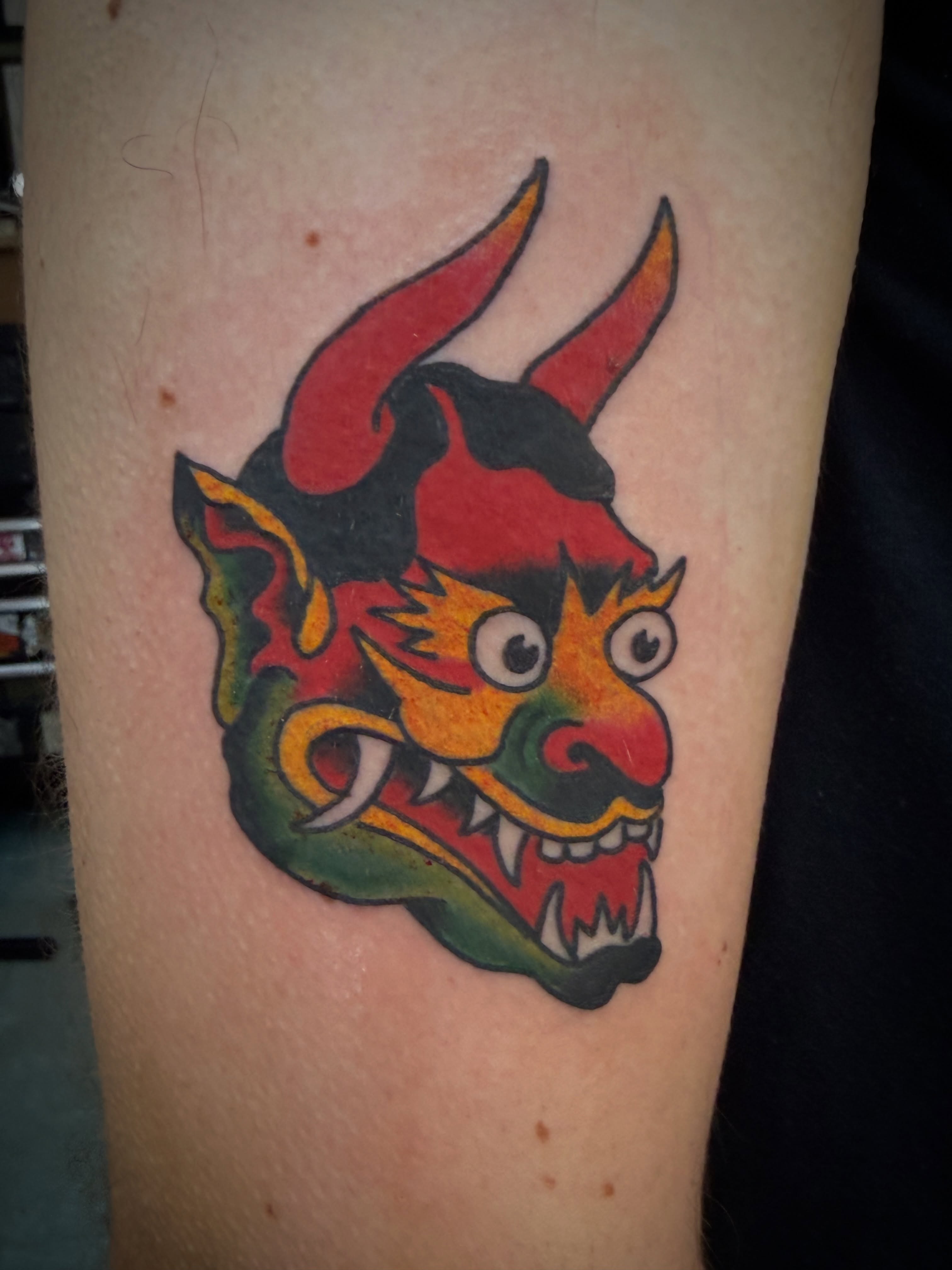 Demon mask American traditional tattoo on the forearm by Chris Blanchard