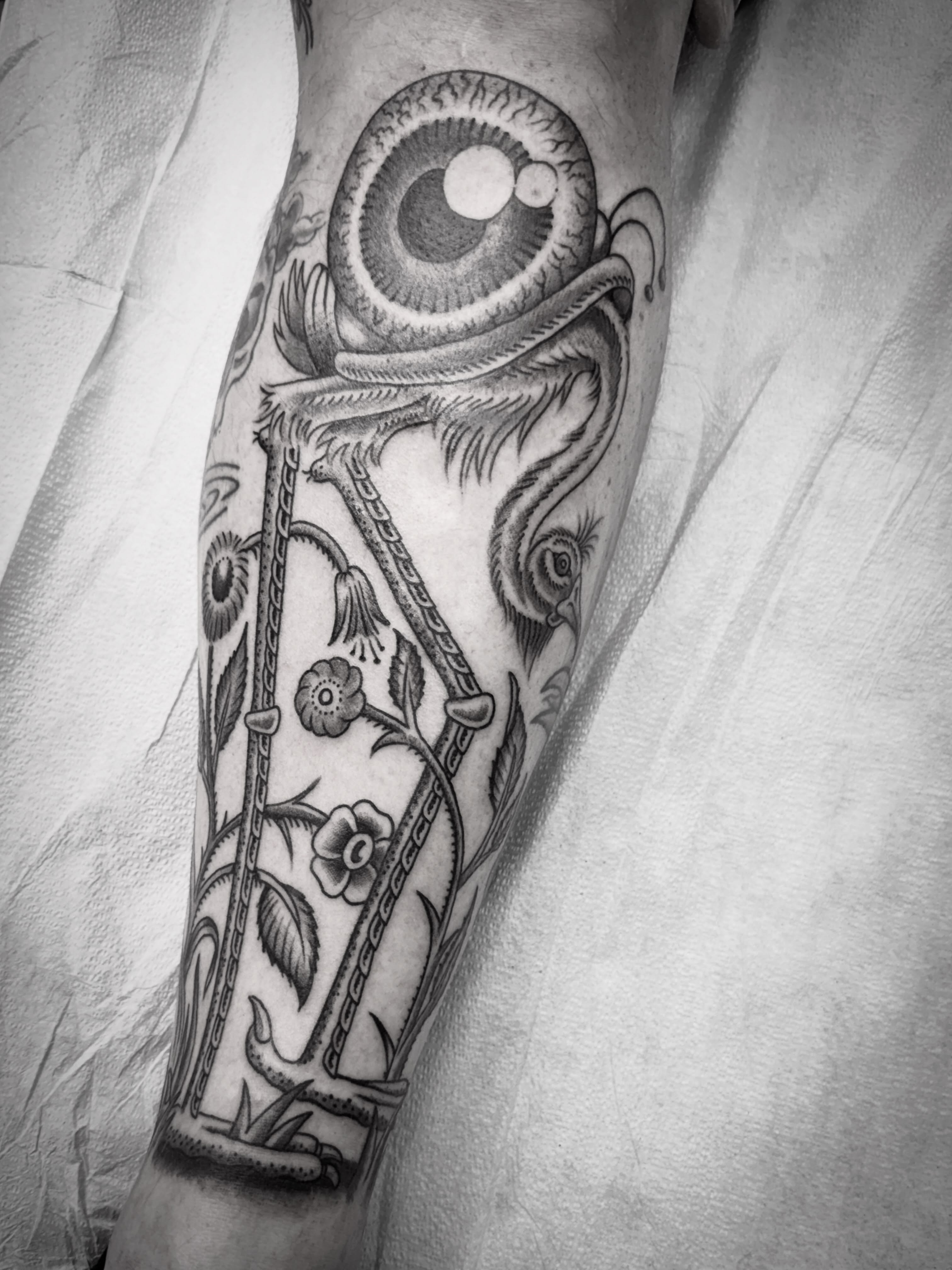 Eye and floral realism tattoo on the forearm by Austin Liebst, Wichita, Kansas