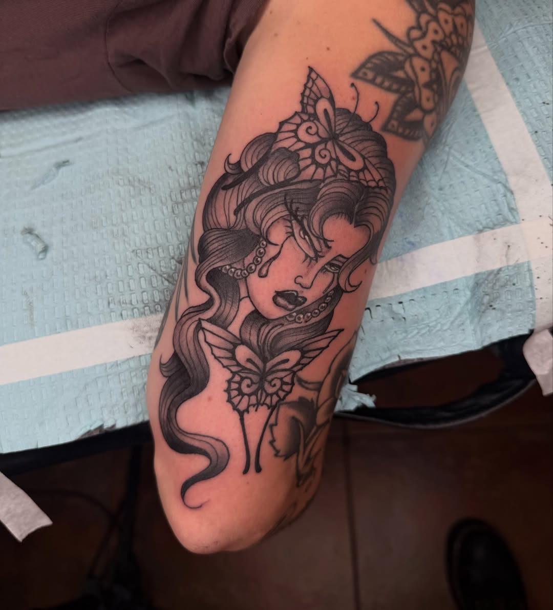 Woman with butterfly realism tattoo on the forearm by Mika Clairissa
